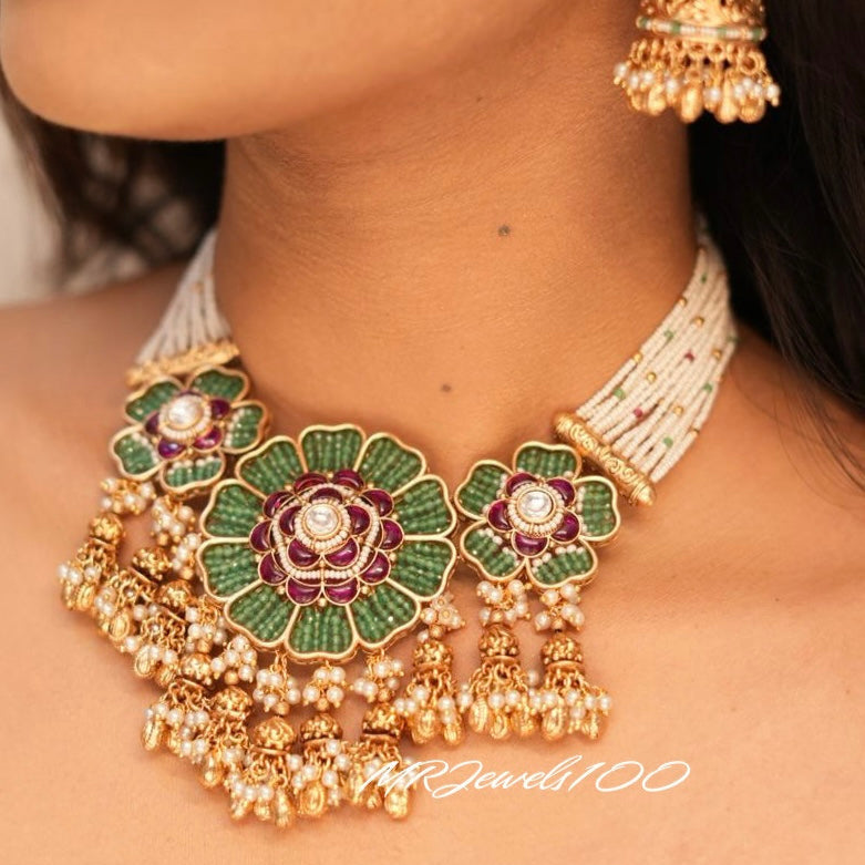 Kundan floral necklace set with ruby and green stones, pearls, and gold detailing