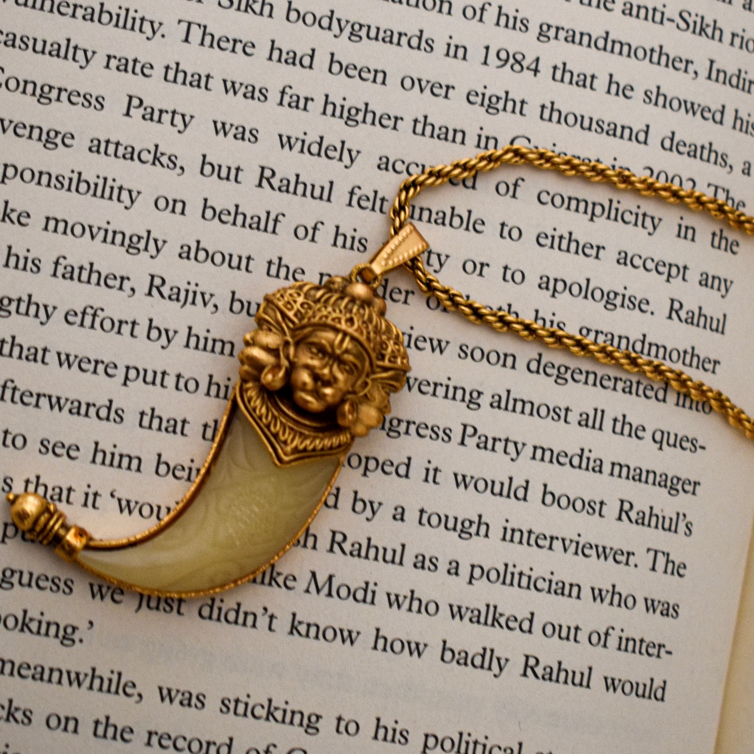 Hanuman tusk necklace with long gold-plated chain and curved pendant design