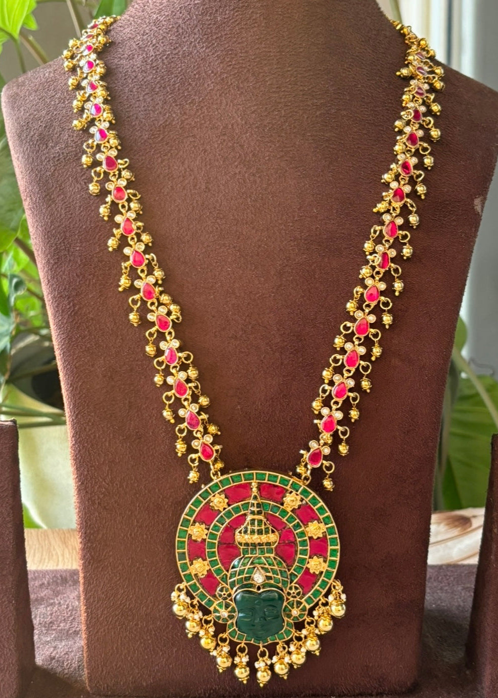 Angled view of traditional temple necklace featuring gold beads and rich enamel finish