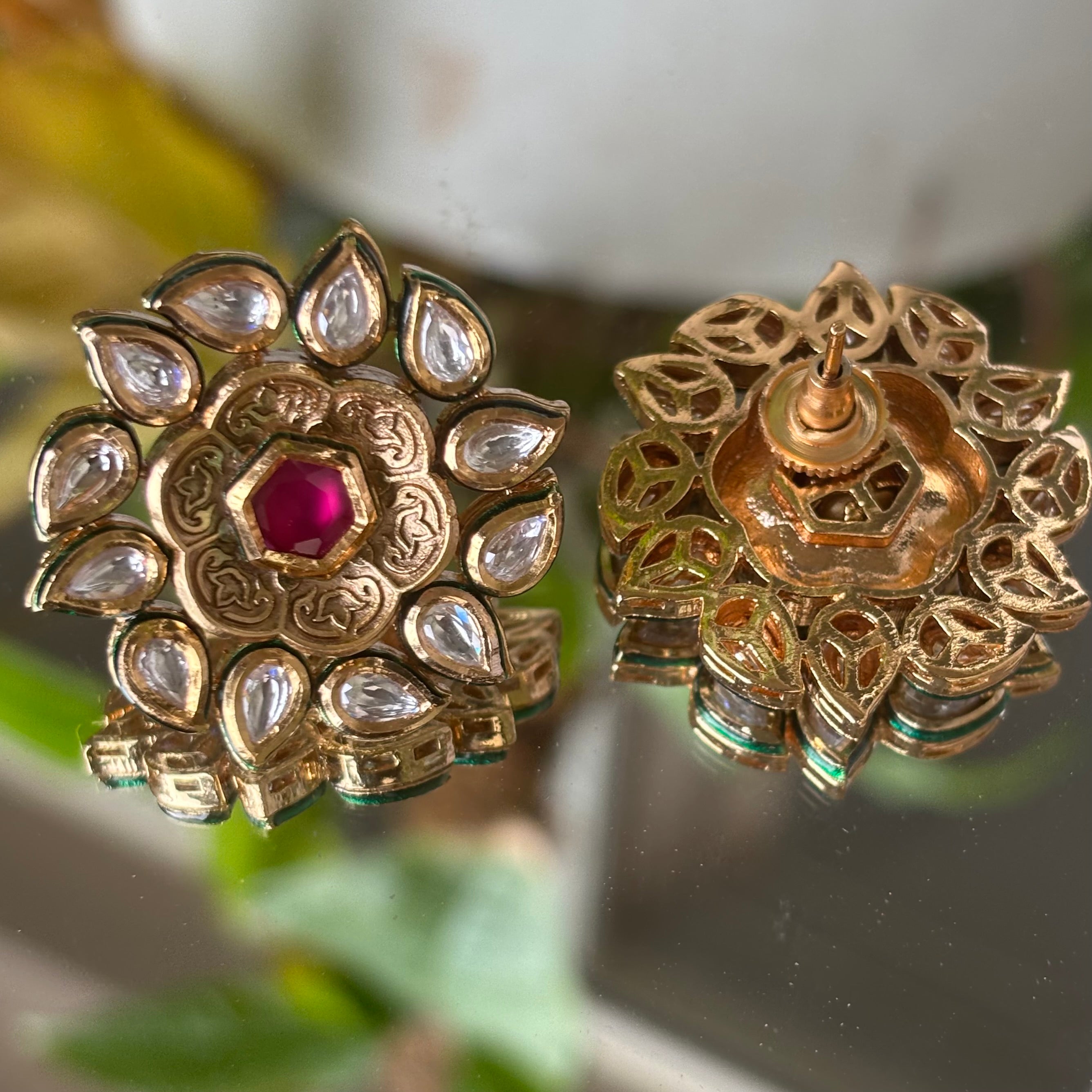 Side profile of Vivienne ruby studs surrounded by radiant uncut diamond halo