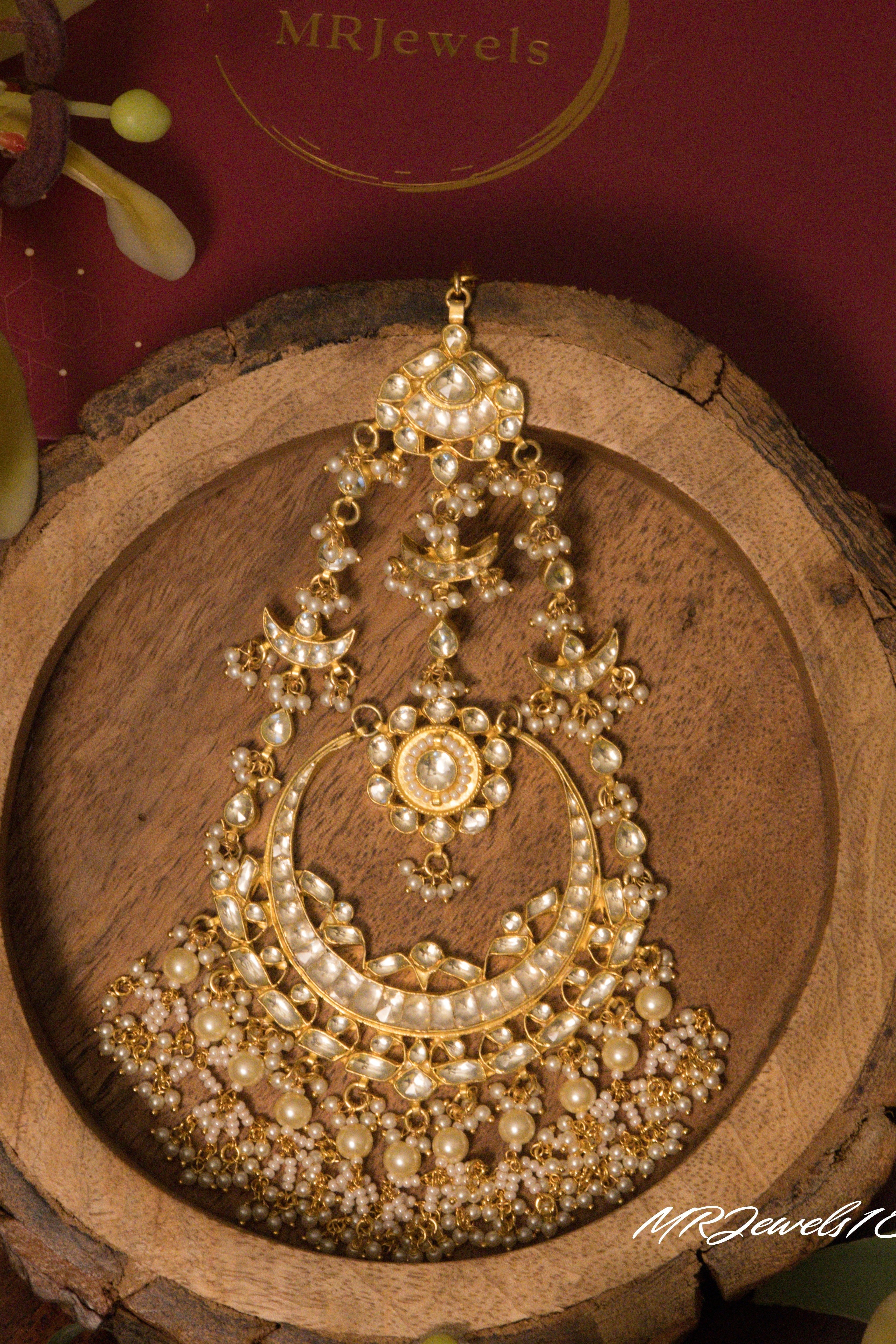 Crescent-shaped pachi kundan passa with layered pearl drapes and fine detailing