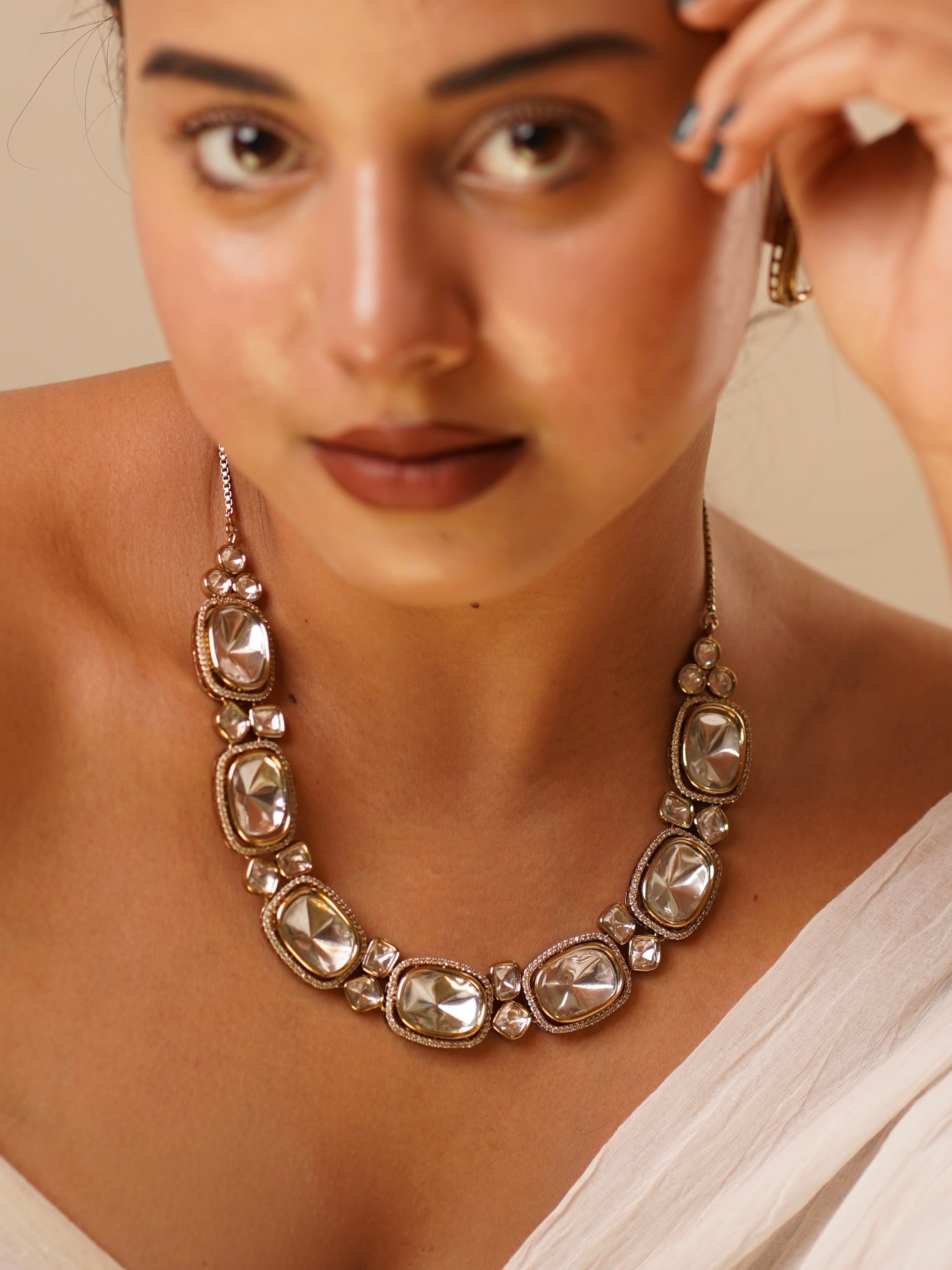 Oversized kundan necklace set with symmetrical gemstone layout and matching maangtikka