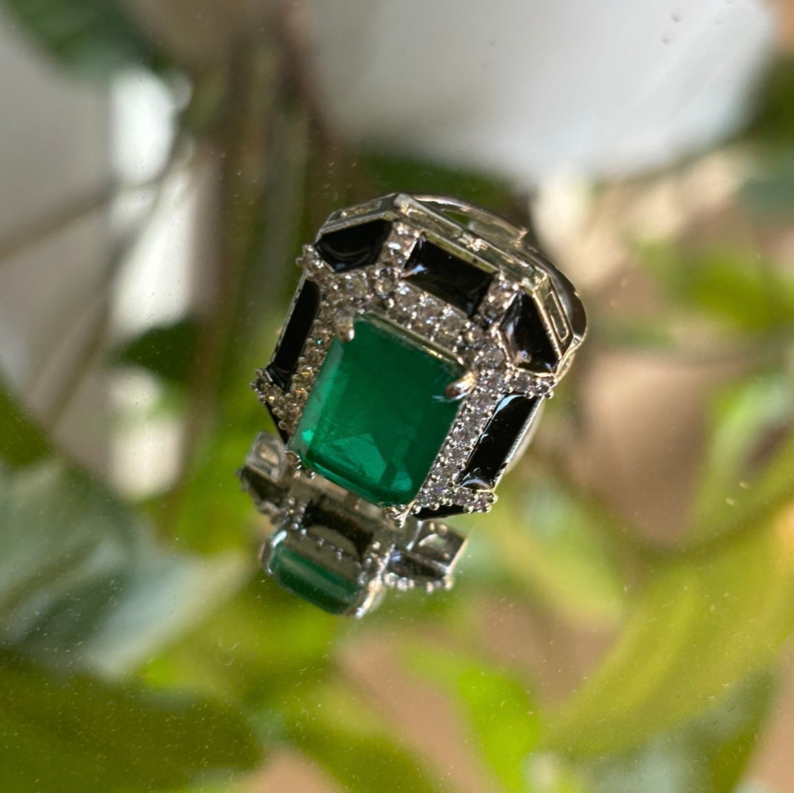 side profile of enamel pendant and adjustable ring with emerald doublet and crystal stones