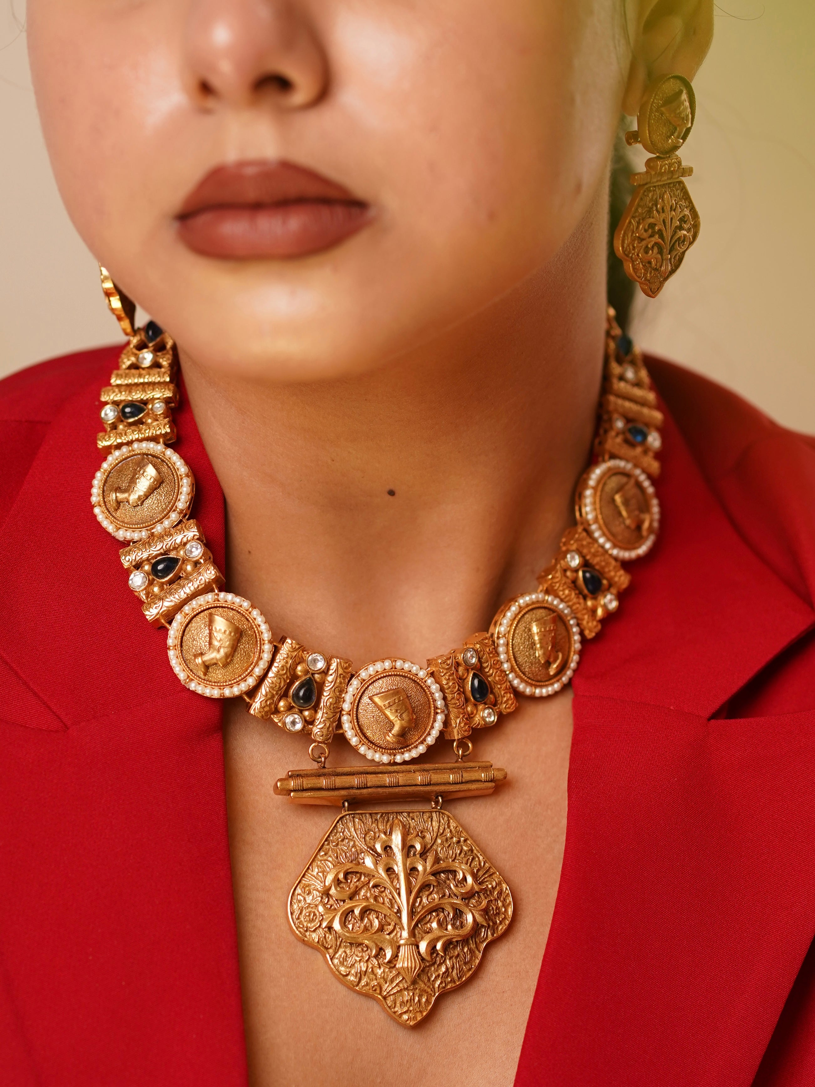 Antique-style necklace with gold coin motifs and pearls, matched with intricate earrings
