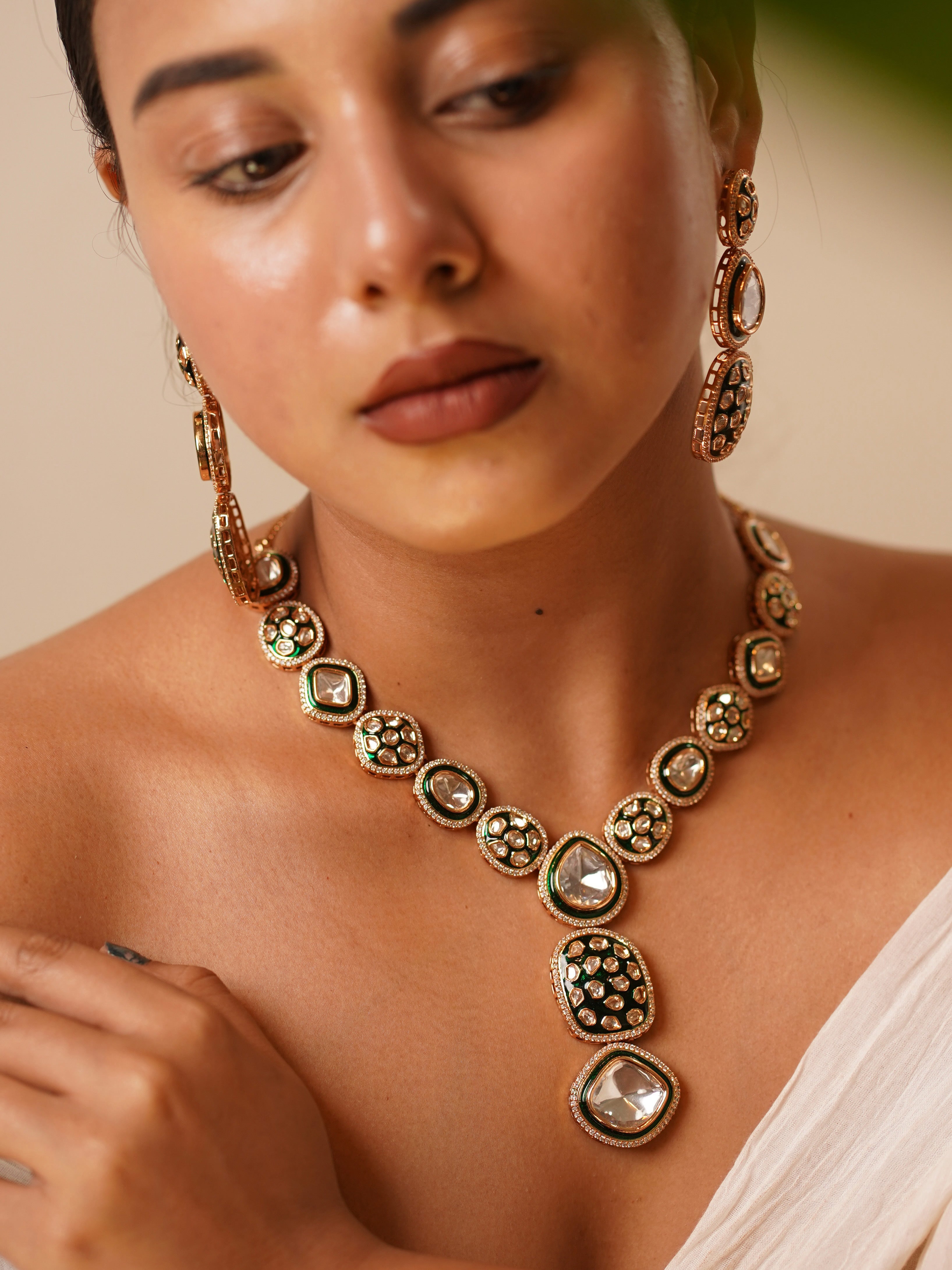 Royal polki necklace with green enamel detailing, matching earrings, and maangtikka