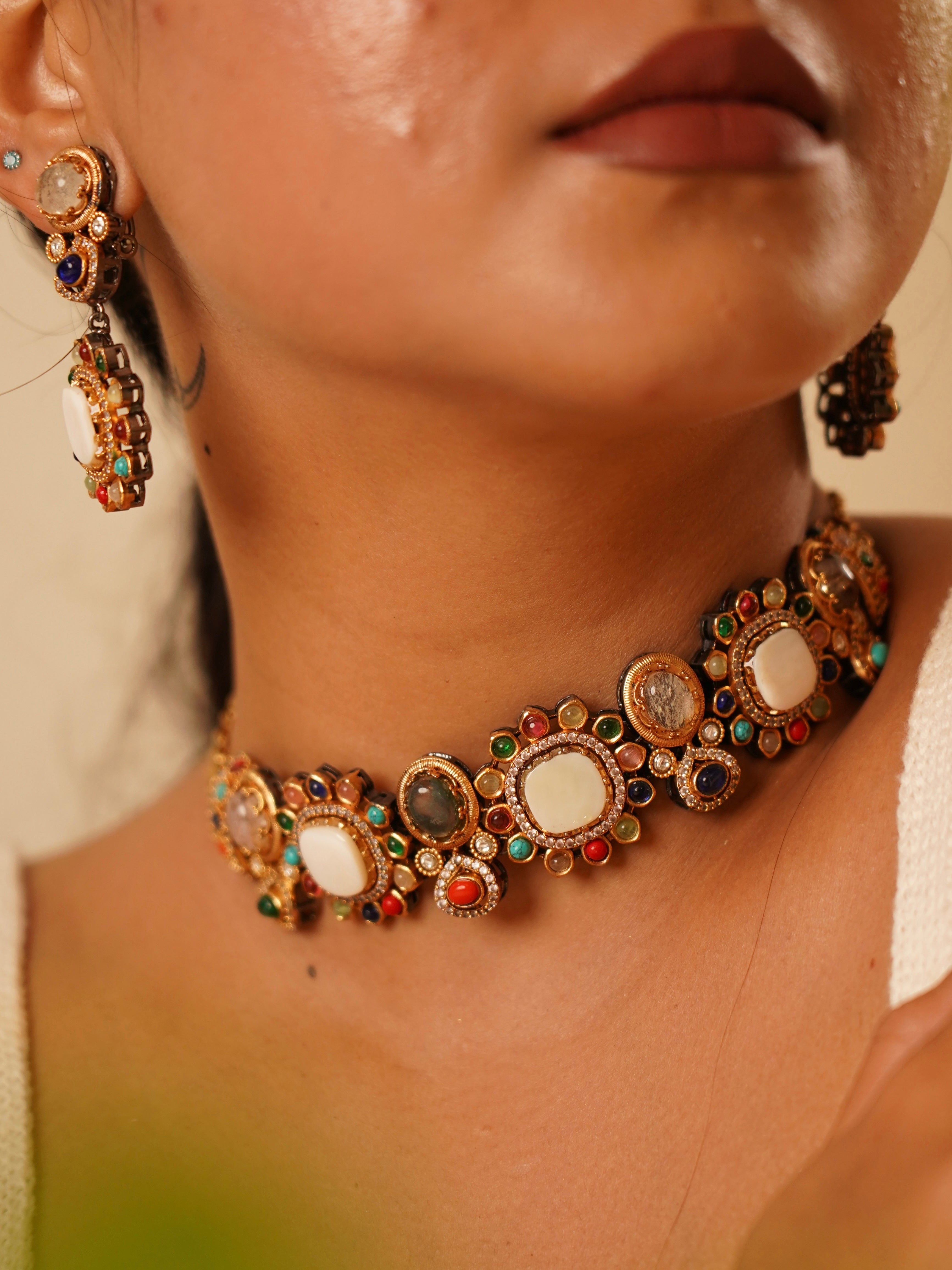 Multigemstone kundan choker set with vibrant navratna layout and antique finish