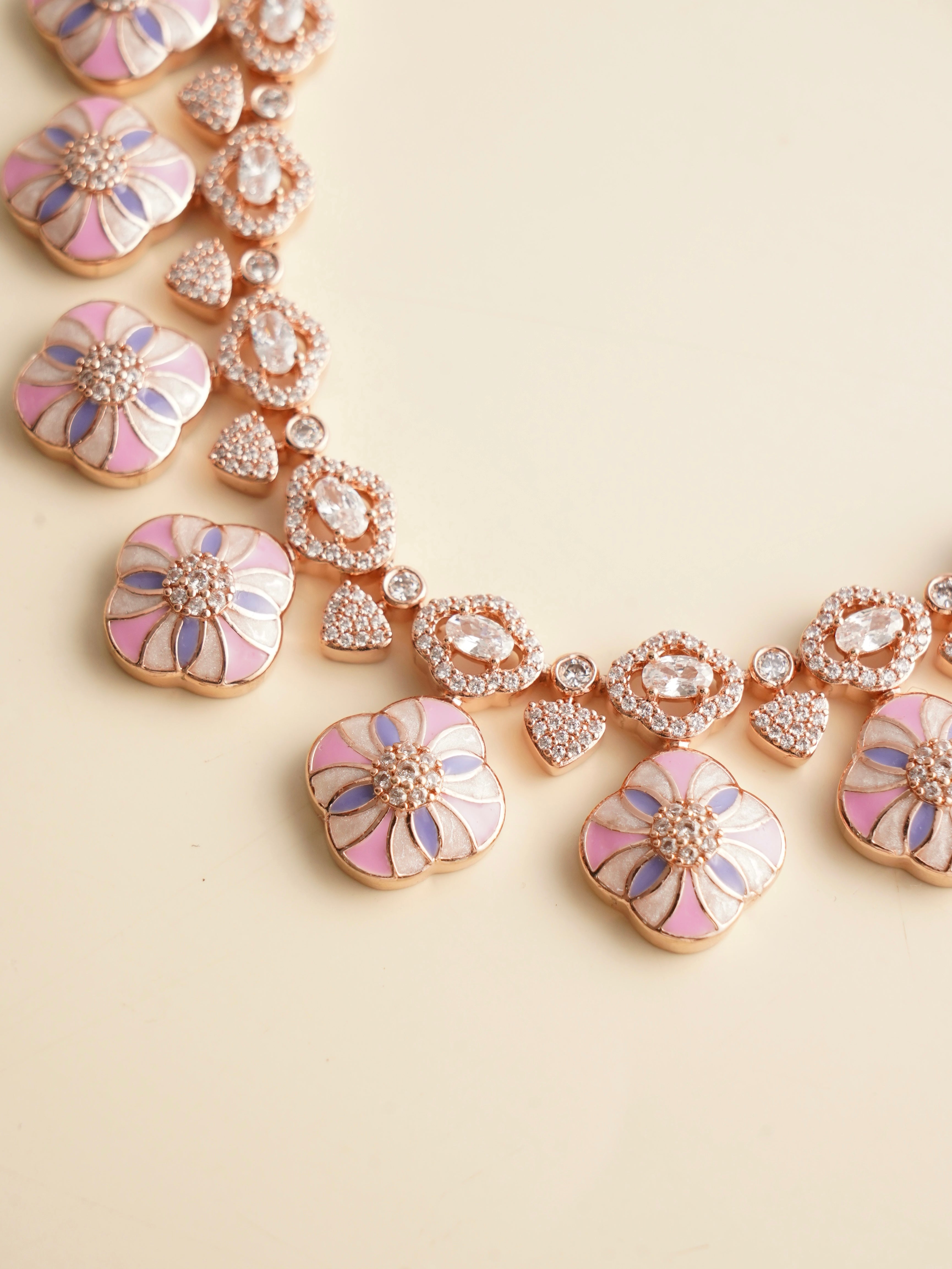 side view of floral-themed meenakari necklace with pink enamel and shimmering stones