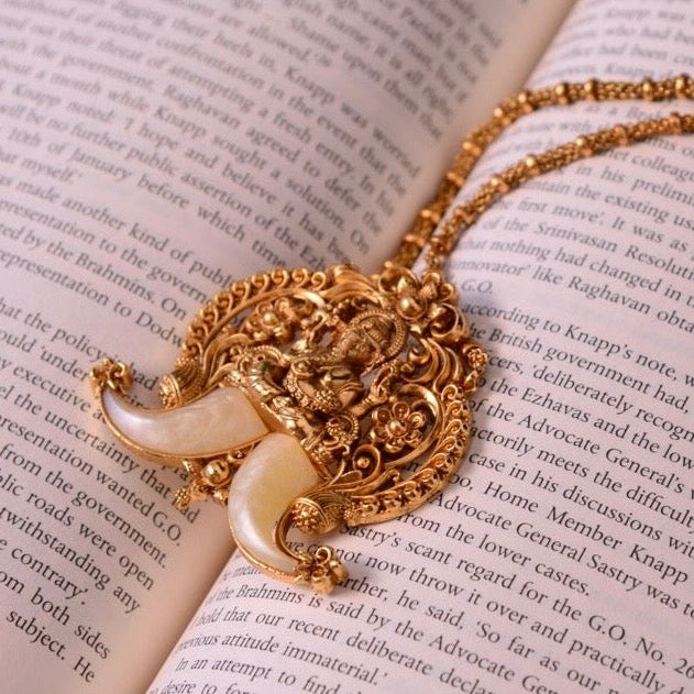 Front view of Ganesha pendant necklace in gold finish with intricate detailing