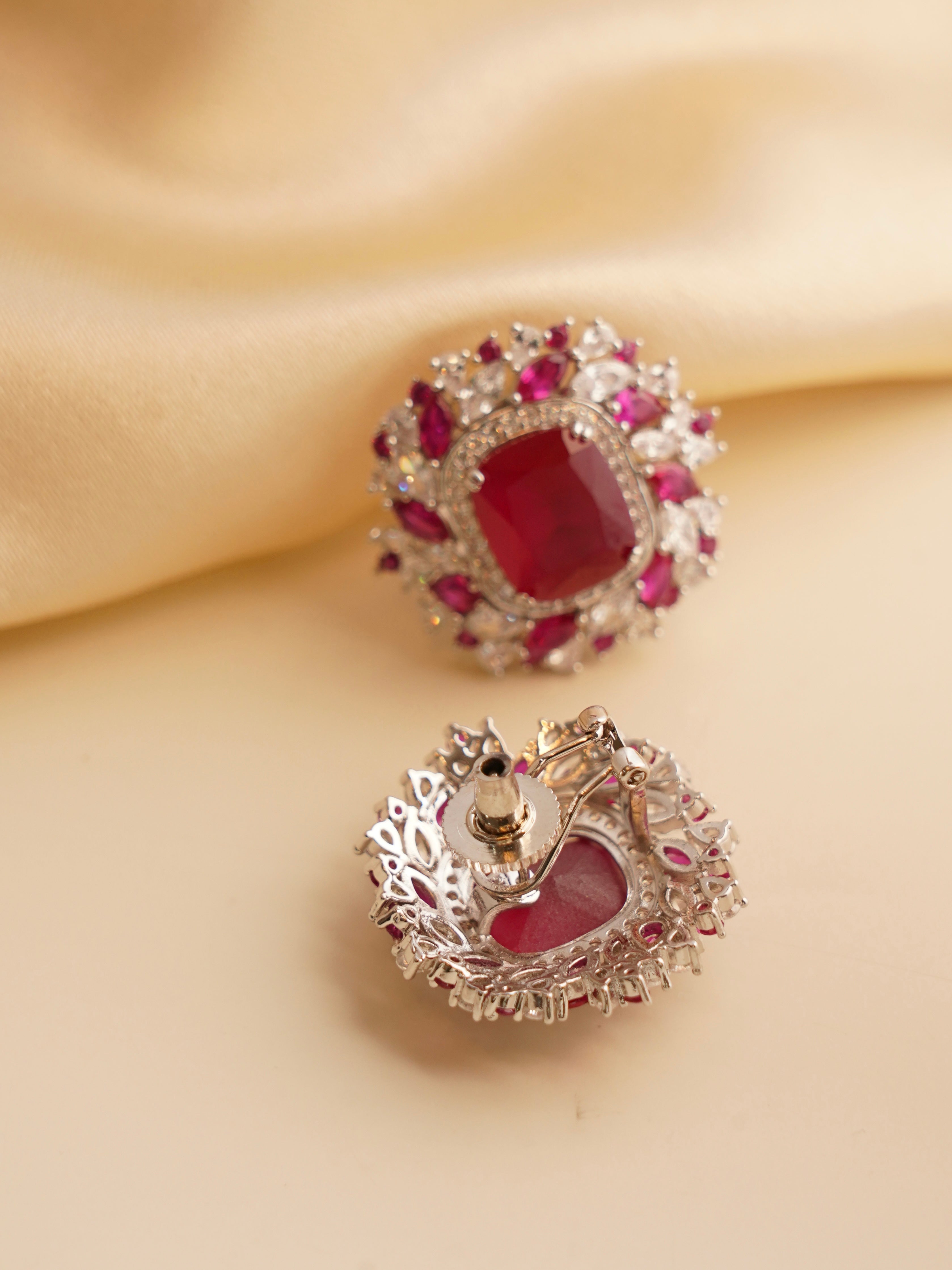 Side view of emerald Swarovski stud earrings with crown-like crystal embellishment