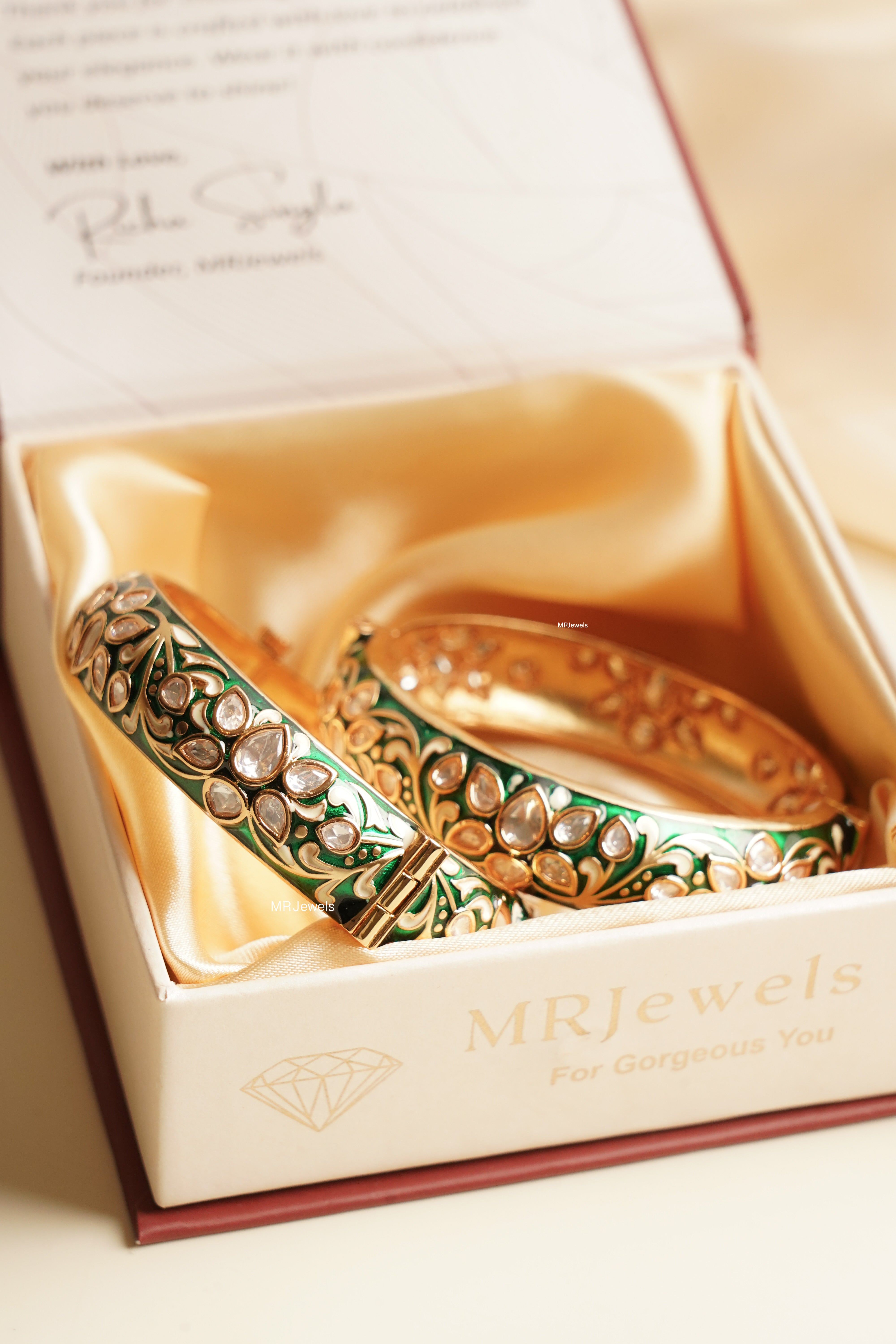 Side profile of meenakari kada with vivid colors and sparkling polki stones