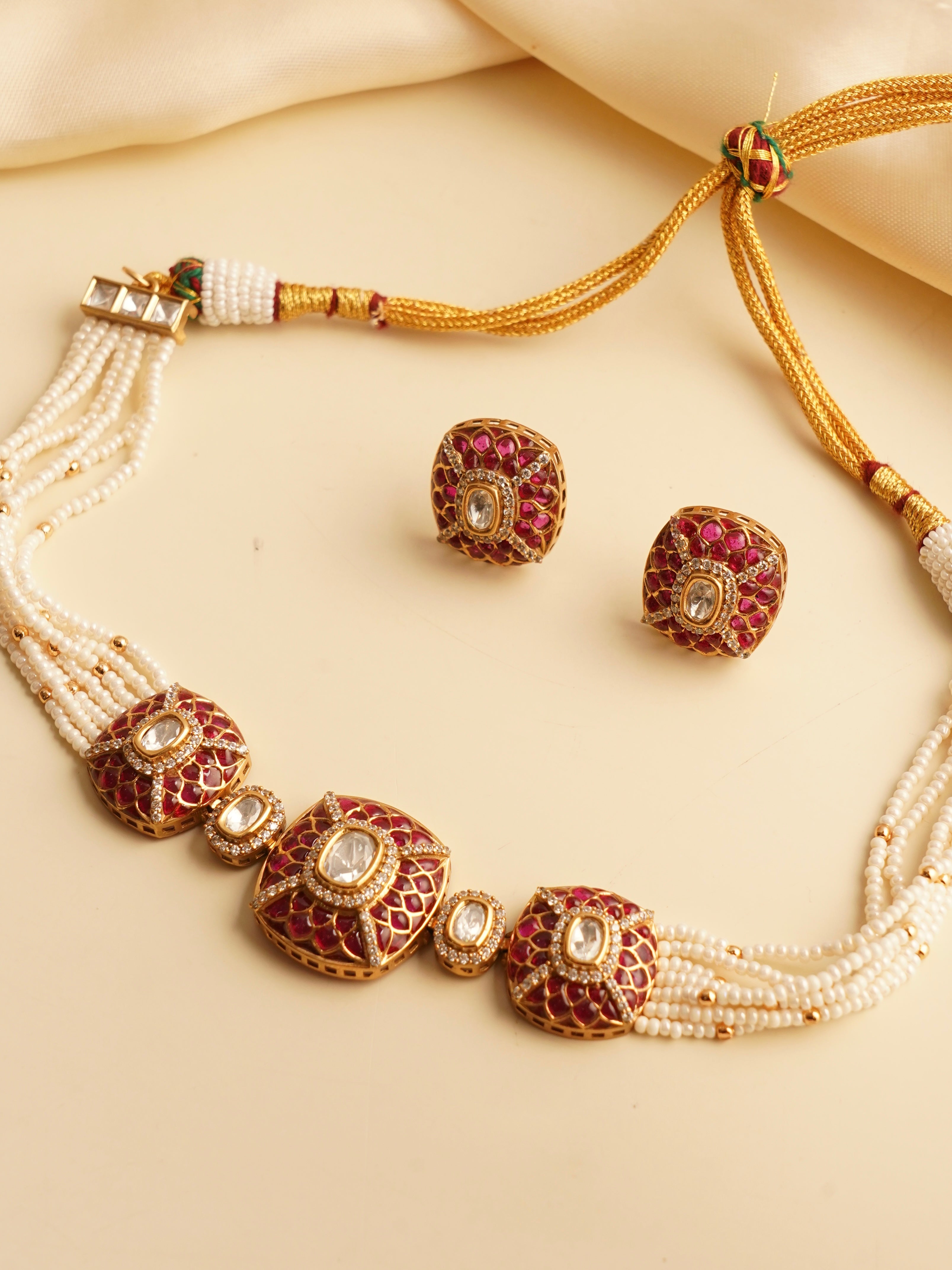 Front view of gold choker set with uncut polki diamonds, pearls, and enamel details