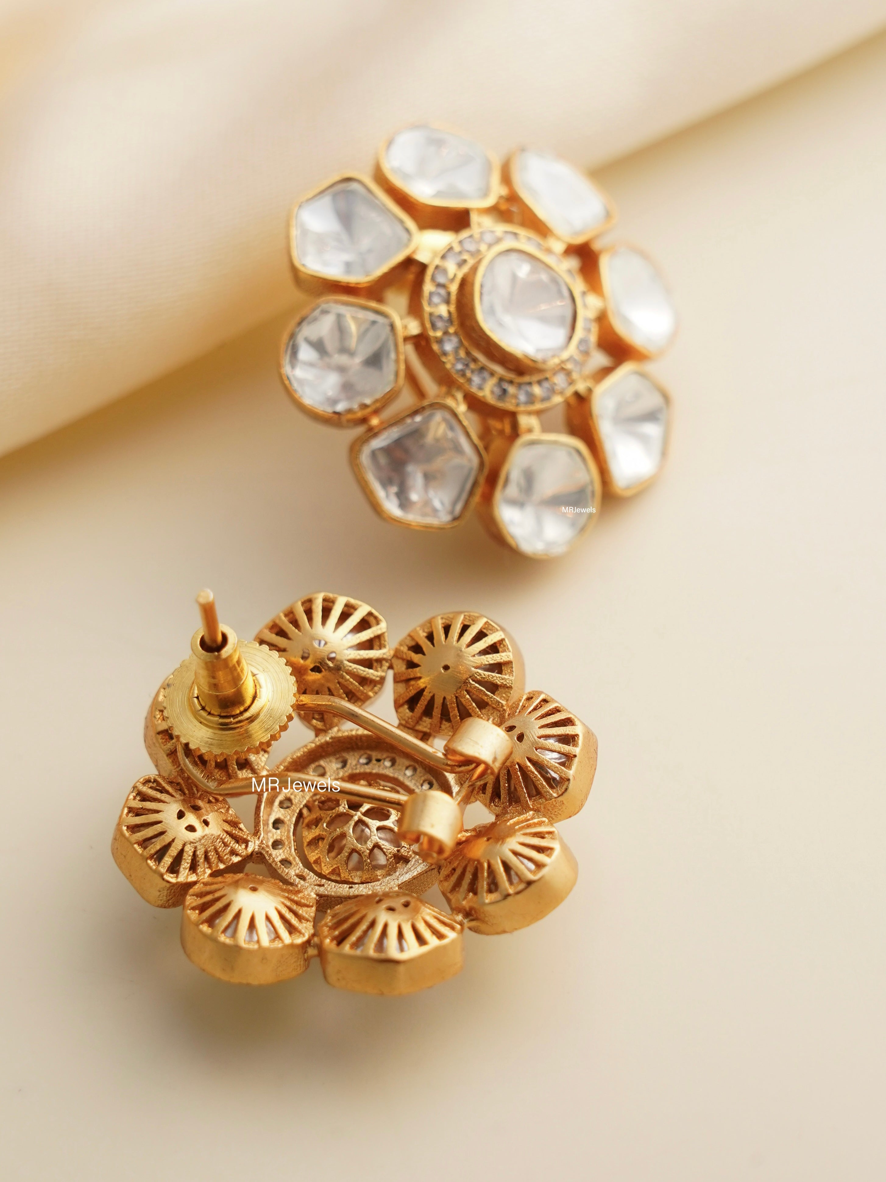 Side view of round moissanite studs with uncut look and smooth gold plating