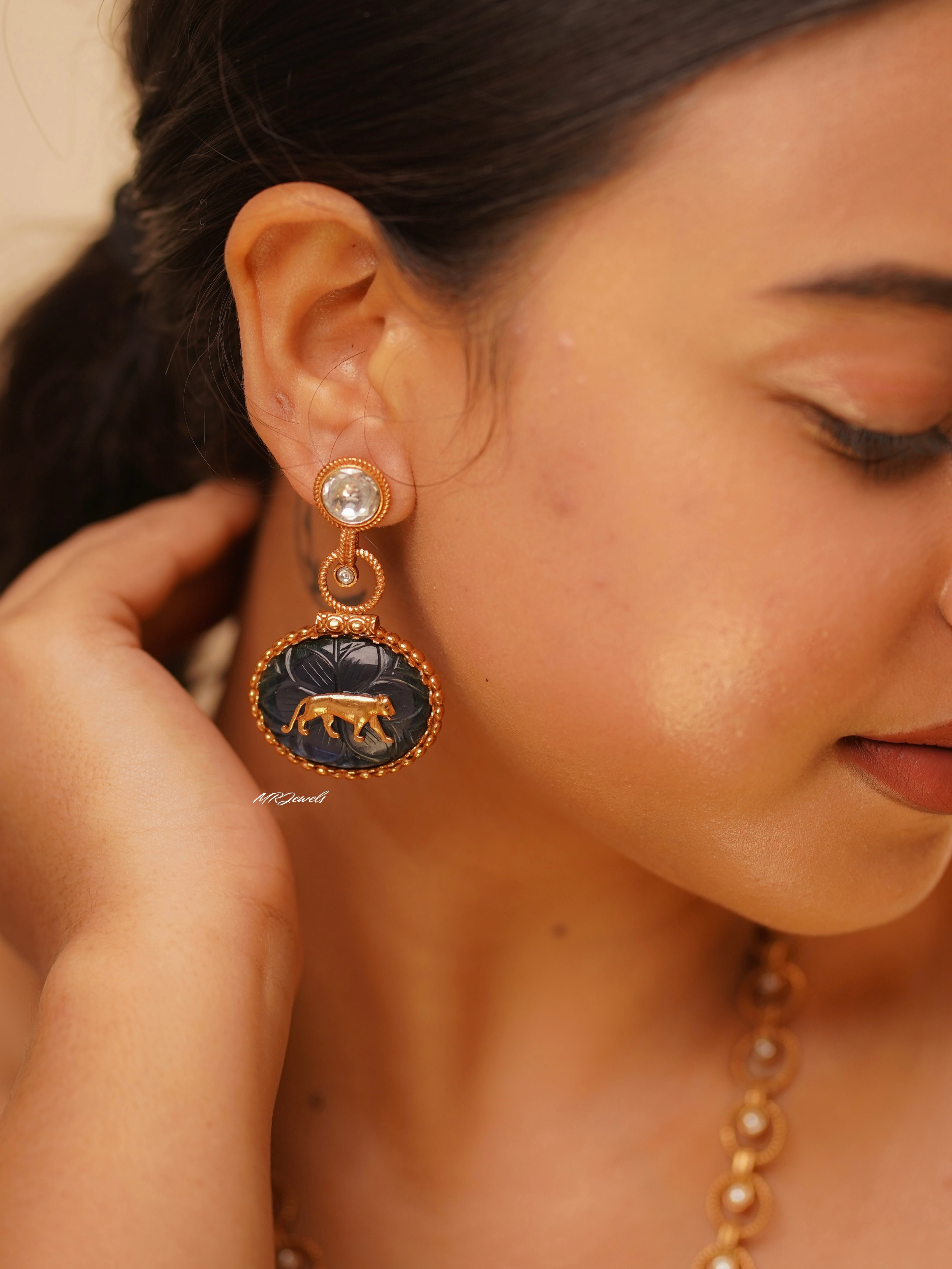 Close-up of earrings from panther motif set showing stone and metal detailing