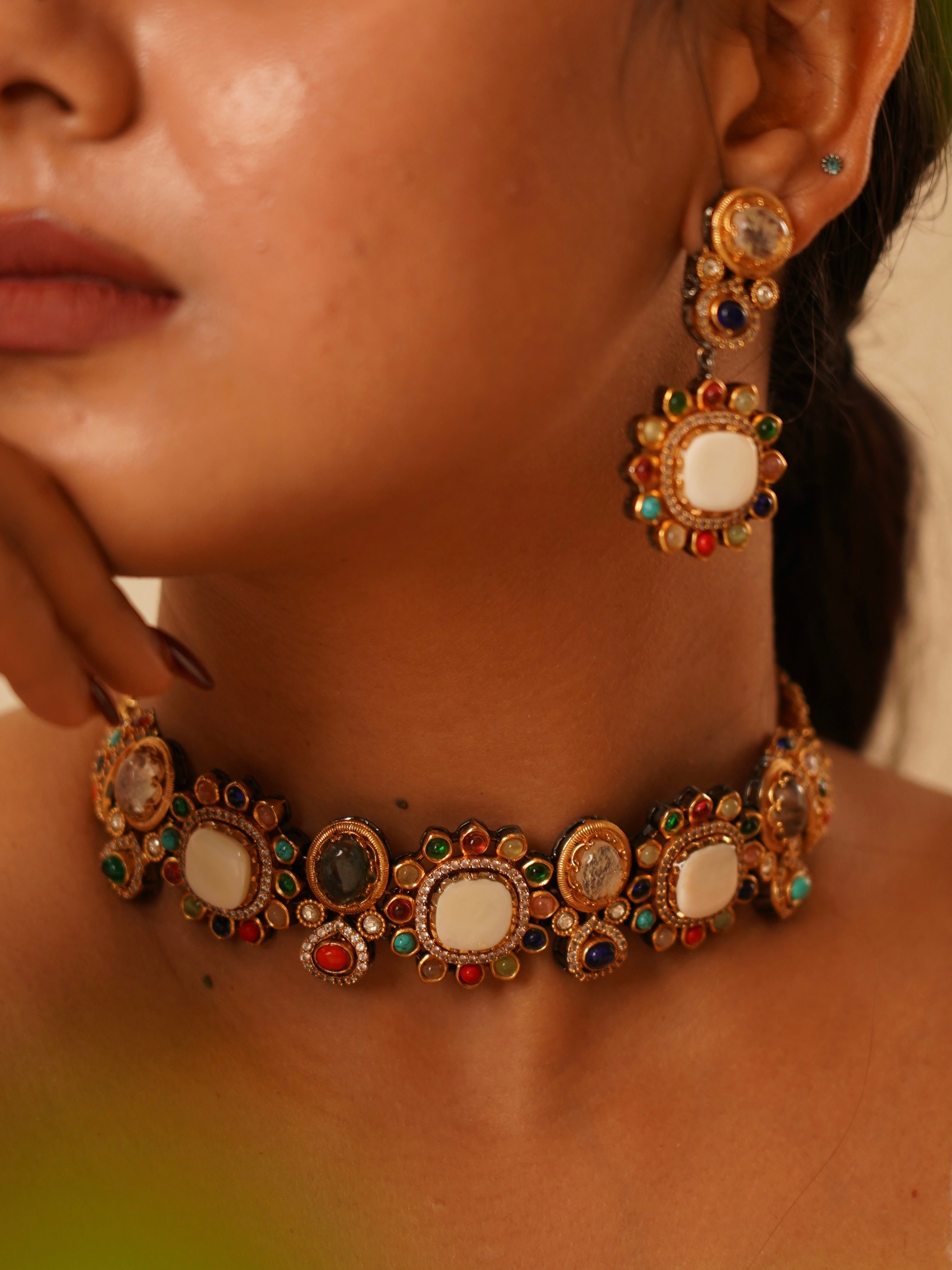 Side profile of kundan choker with white stones and celestial-inspired gems