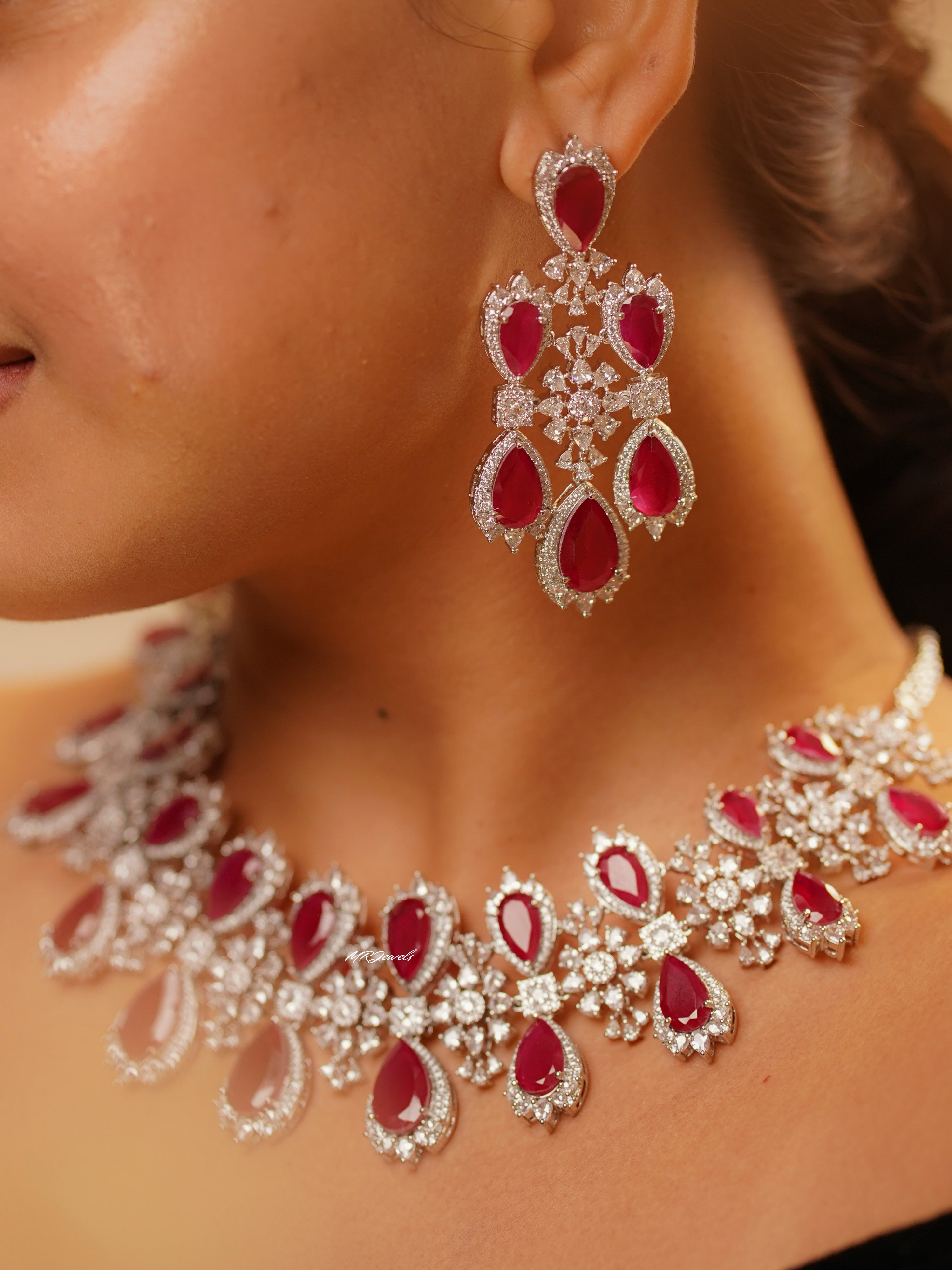 Close-up of urvi necklace earring with circular design and layered gemstone accents