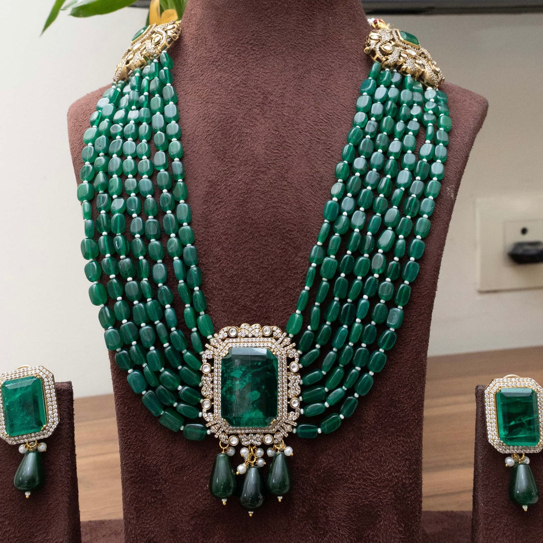 Multi-strand emerald necklace with layered green stones, frontal display