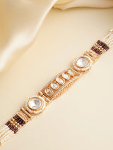 Top-down view of rakhi bracelet with pearl strands and kundan centre