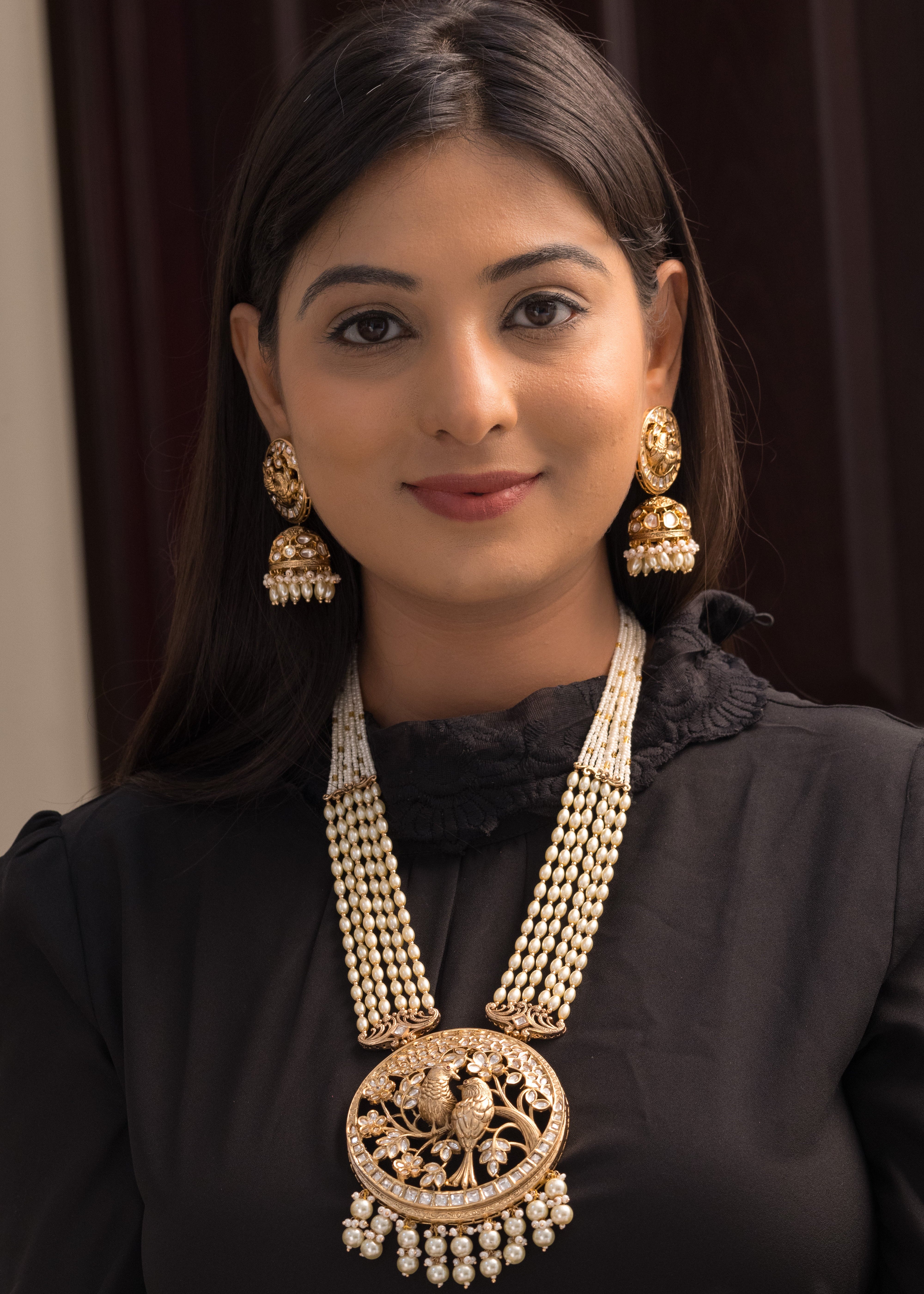 bird motif necklace with pearl strands and floral detailing, paired with matching earrings