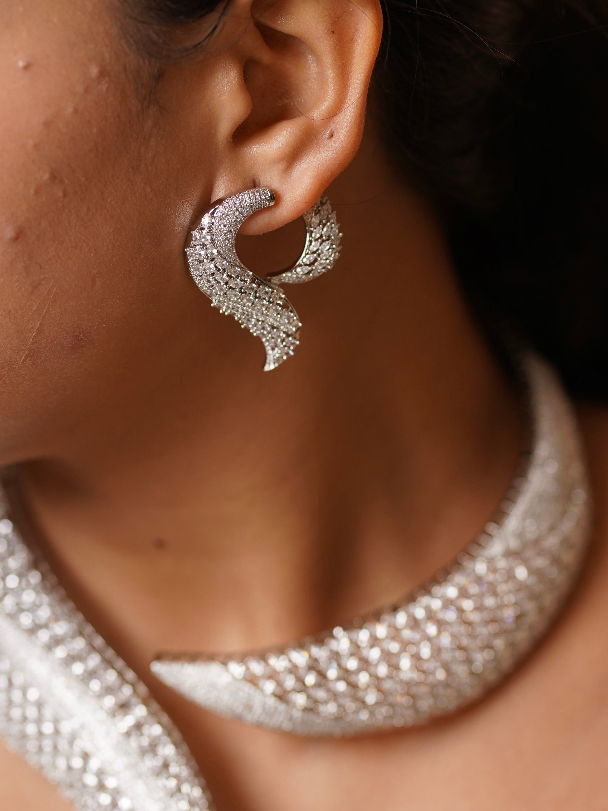 Angled image of diamond jewellery set featuring collar design with sparkling accents