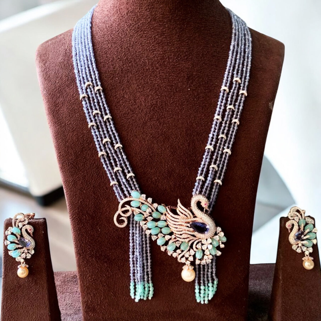 close-up of royal peacock necklace featuring intricate gemstone work and ornate design