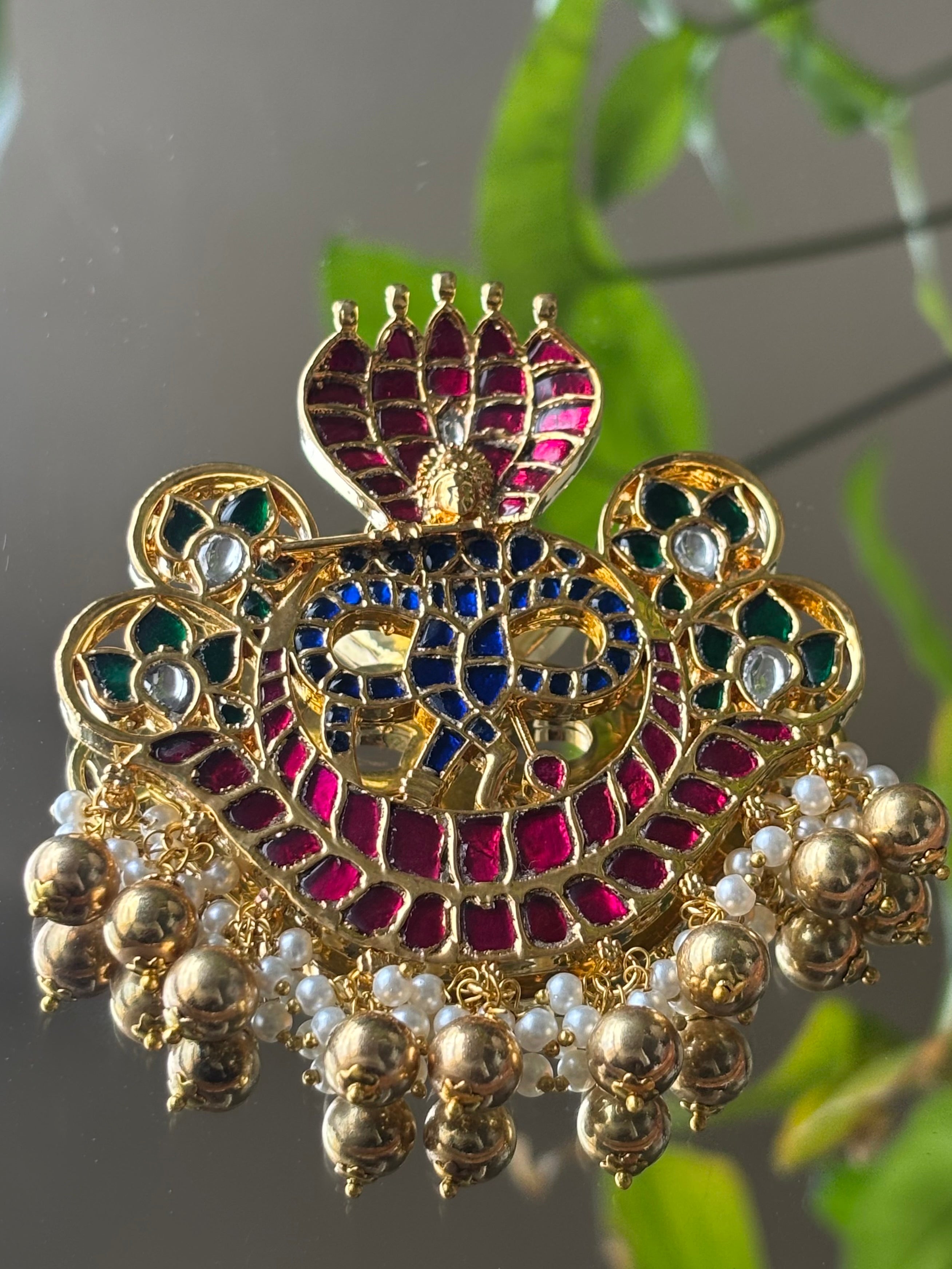Close-up highlighting detailed meenakari and ghungroo accents on pendant