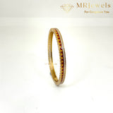 Top view of enamel bracelet highlighting clasp and sleek gold-plated surface