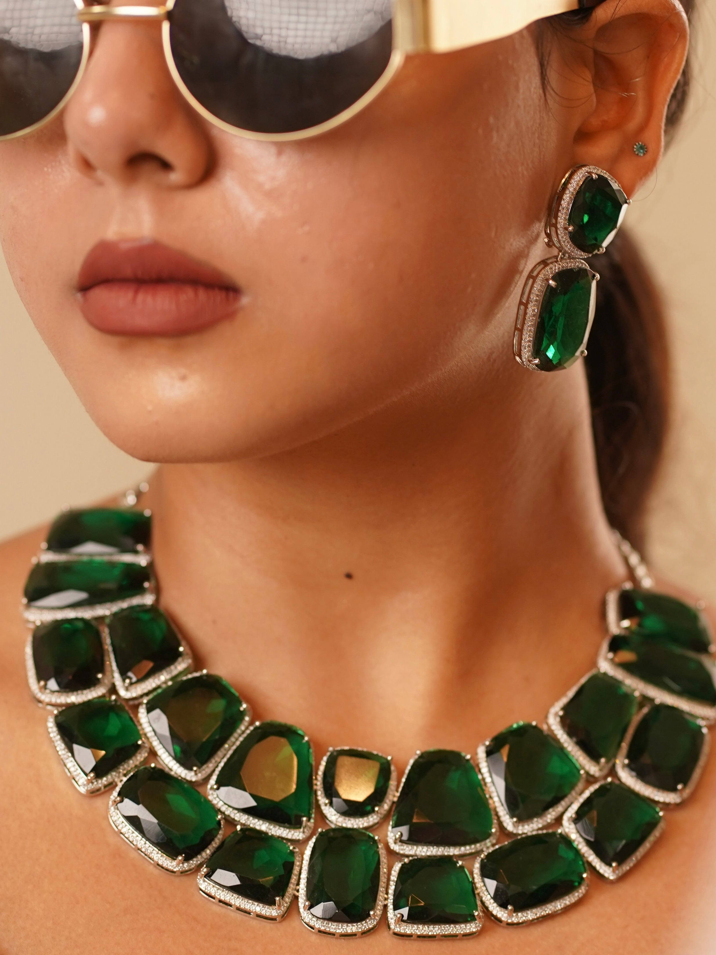 Close-up of emerald luxe set necklace highlighting bold faceted stones and vintage-style finish