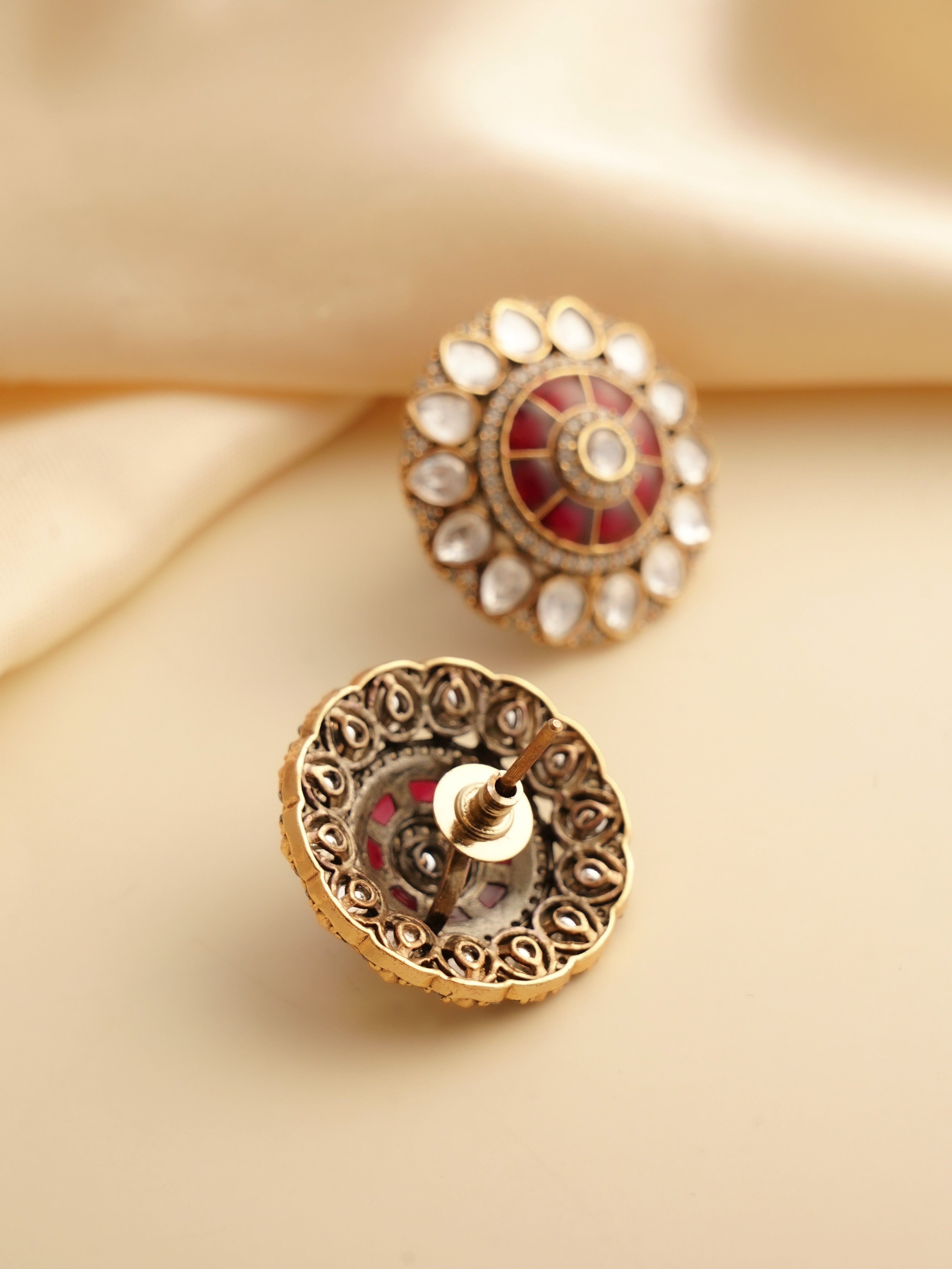 Close-up of moissanite ruby studs showcasing central red stone and dazzling halo