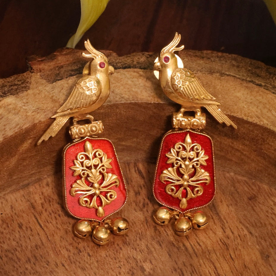 Handcrafted earrings with carved design and gold plating, front angle view