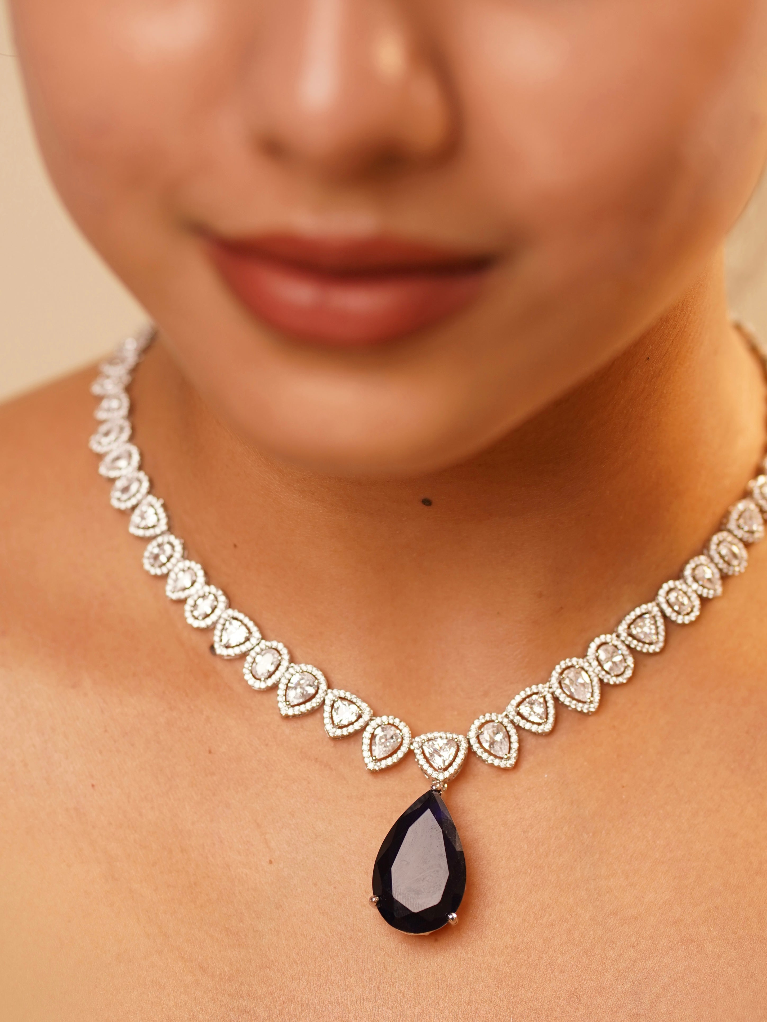 Seraphina diamond set with yellow pear-cut center stone and diamond-studded halo