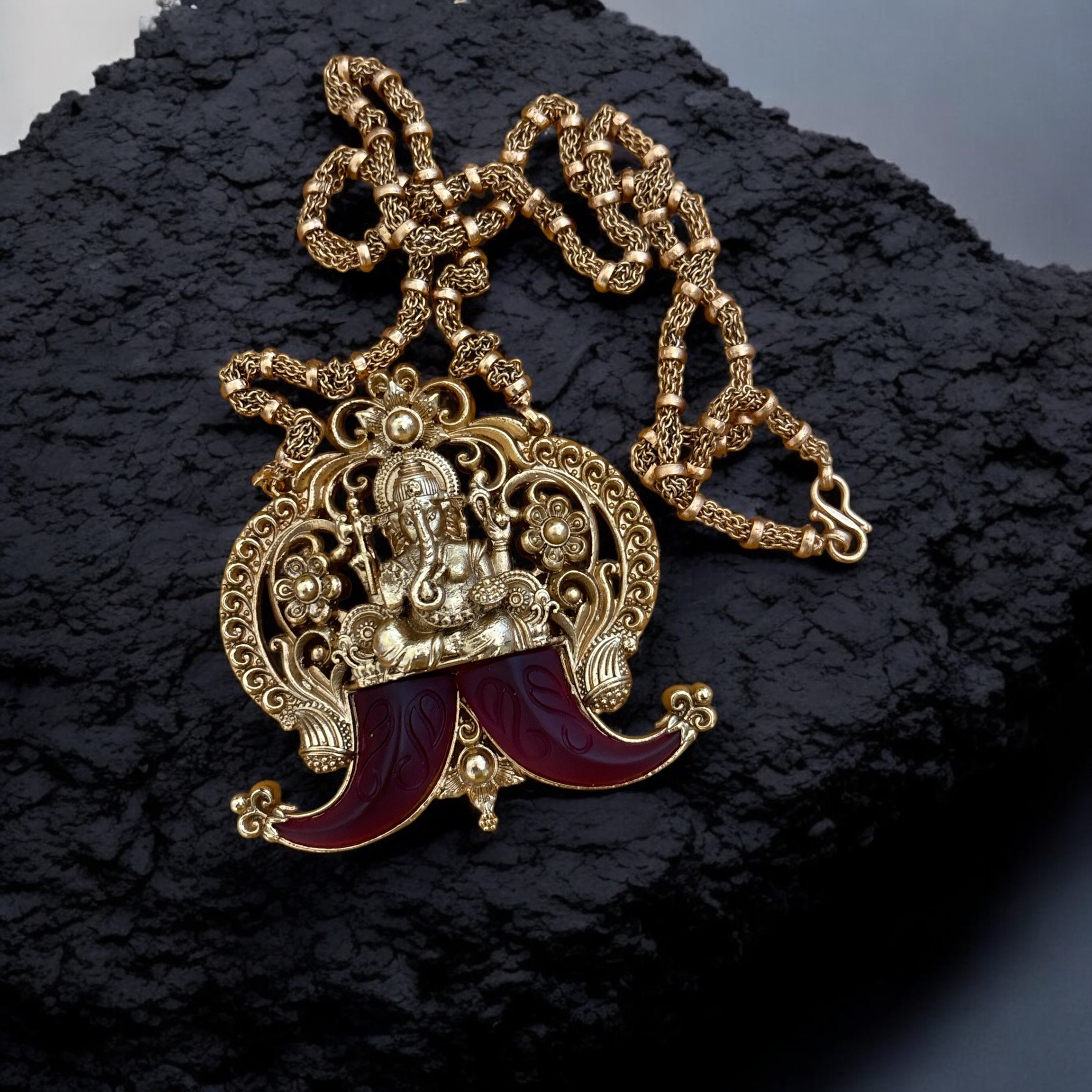 Side angle of divine Ganesha necklace featuring carved pendant and chain