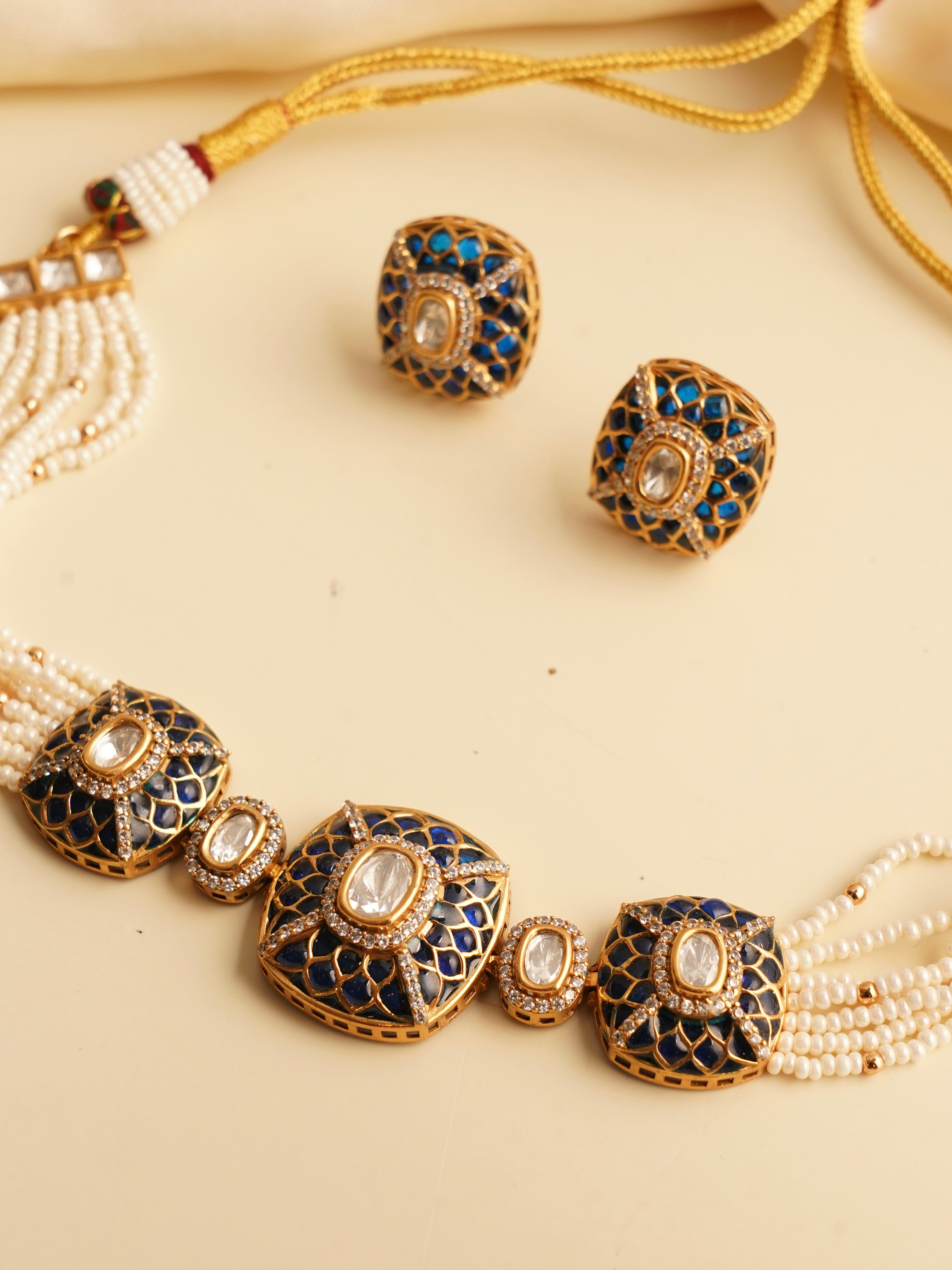 Side view of multi-strand pearl choker with gold finish and polki Kundan stones