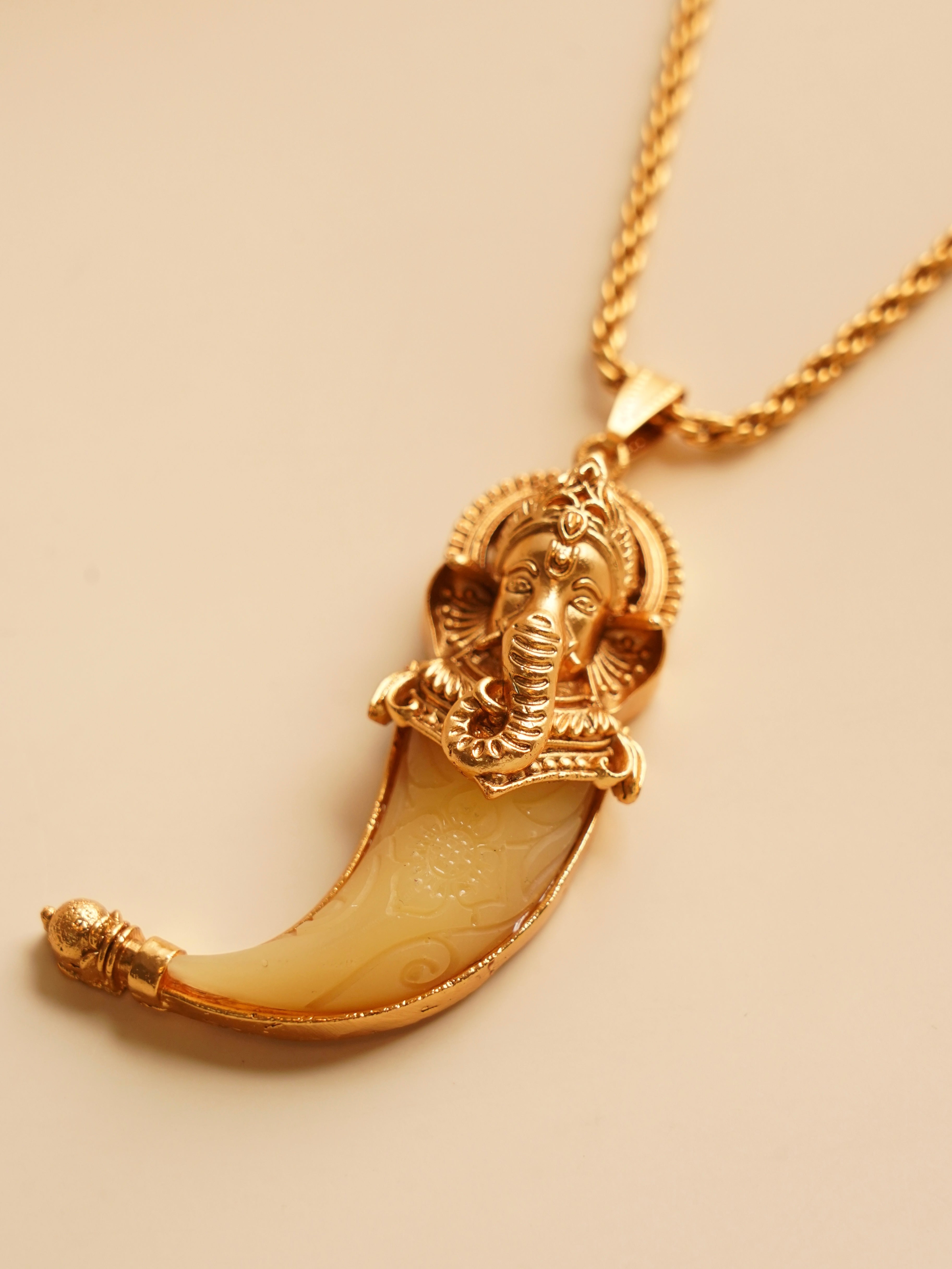 Angled view of ganesha pendant necklace highlighting shine and chain length