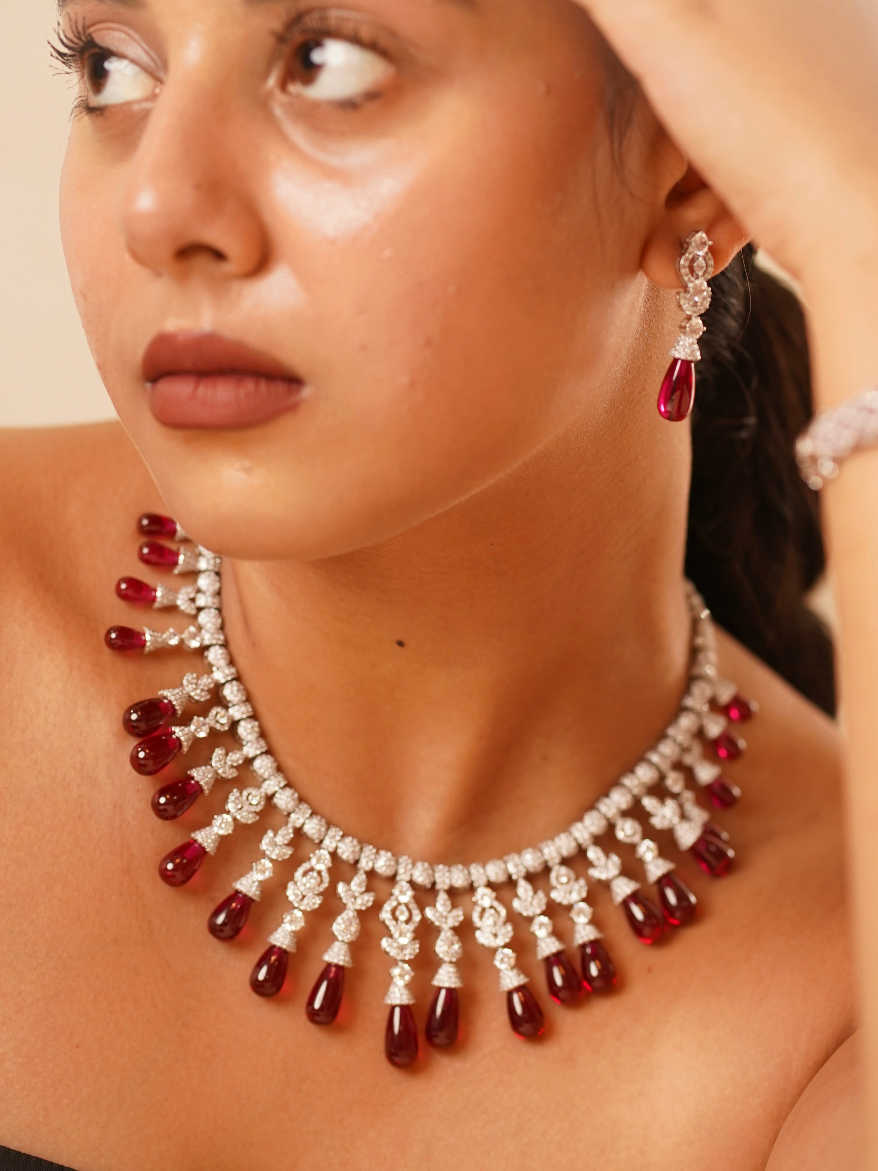Close-up of Scarlet Royale necklace featuring deep red gemstones and sparkling CZ work