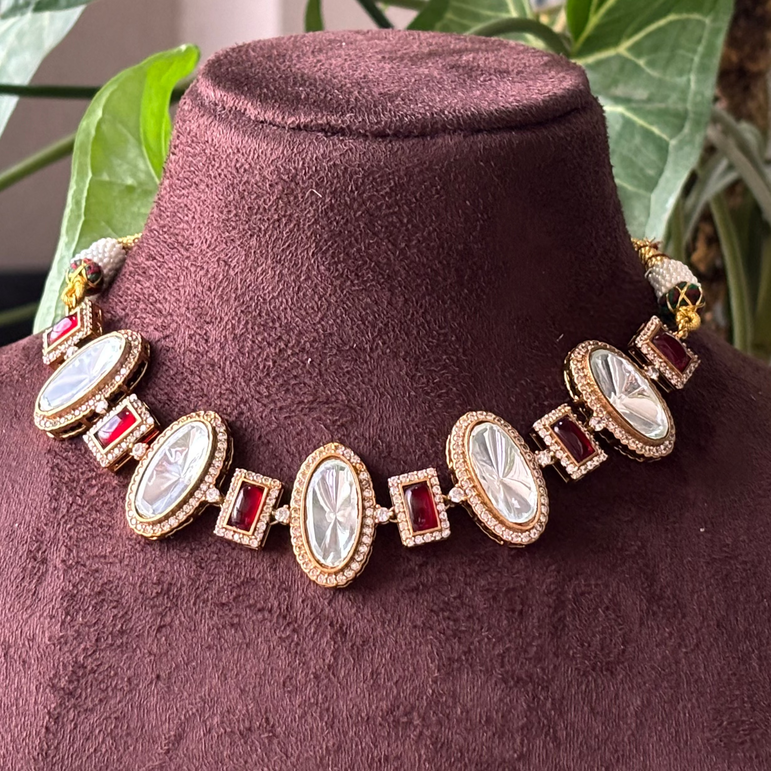 Front view of uncut polki kundan necklace with CZ stones and red accents