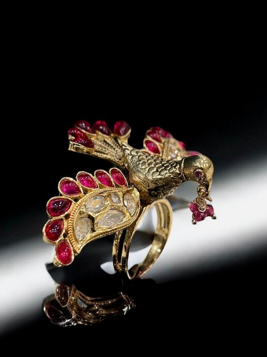 Close-up of flying bird ring showcasing intricate feathers and colourful enamel craftsmanship