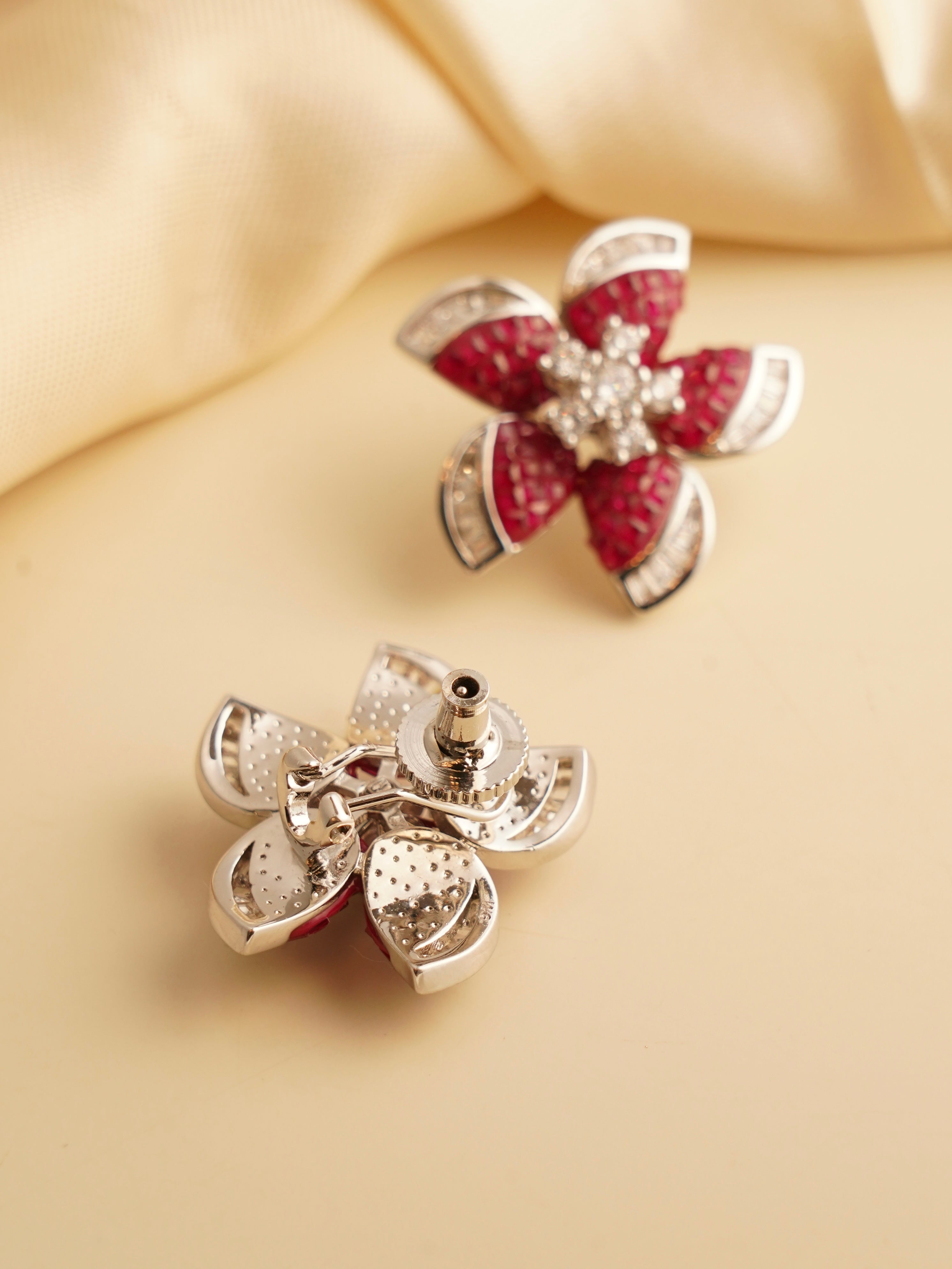 Side view of ruby earrings with invisible stone setting and rhodium plating