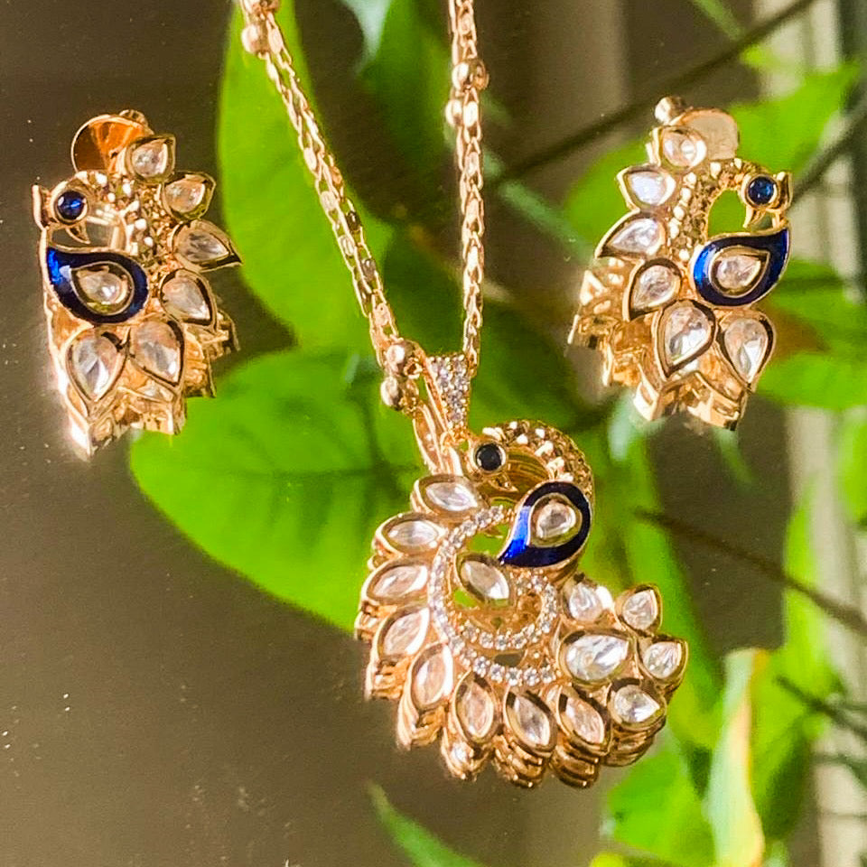 Peacock pendant set with kundan and enamel detailing in front view