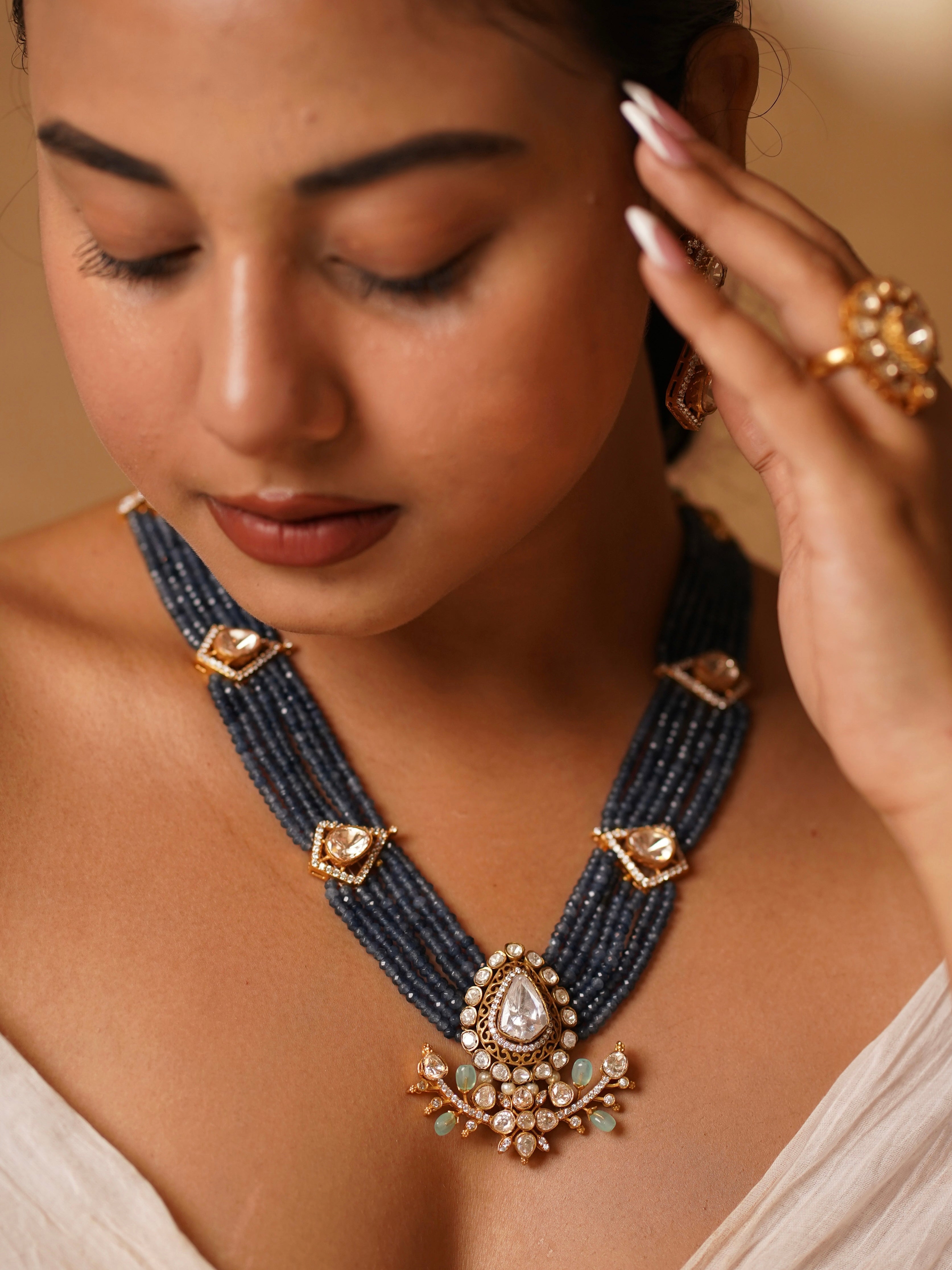 Kundan choker with lotus enamel motifs and blue-green stone accents