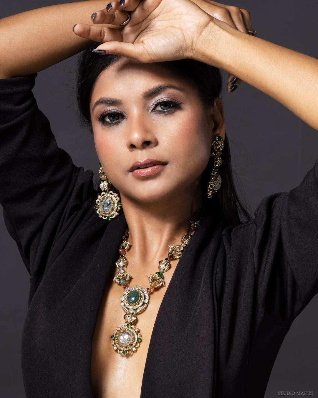Aurora medallion necklace set with natural stones and ornate medallion detailing