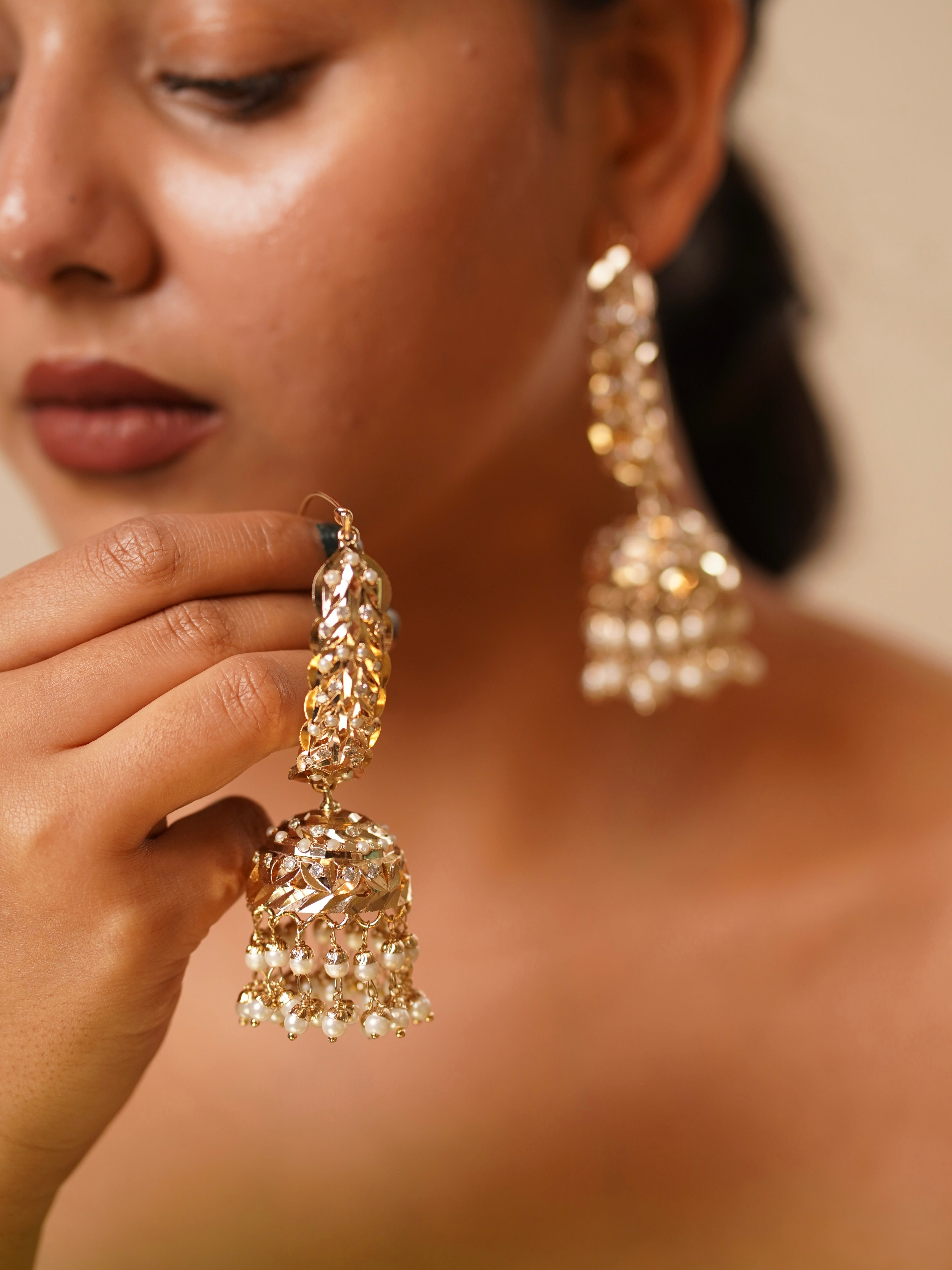 Jadau chaandbaali earrings with pearl drops, gemstone accents, and intricate gold filigree work