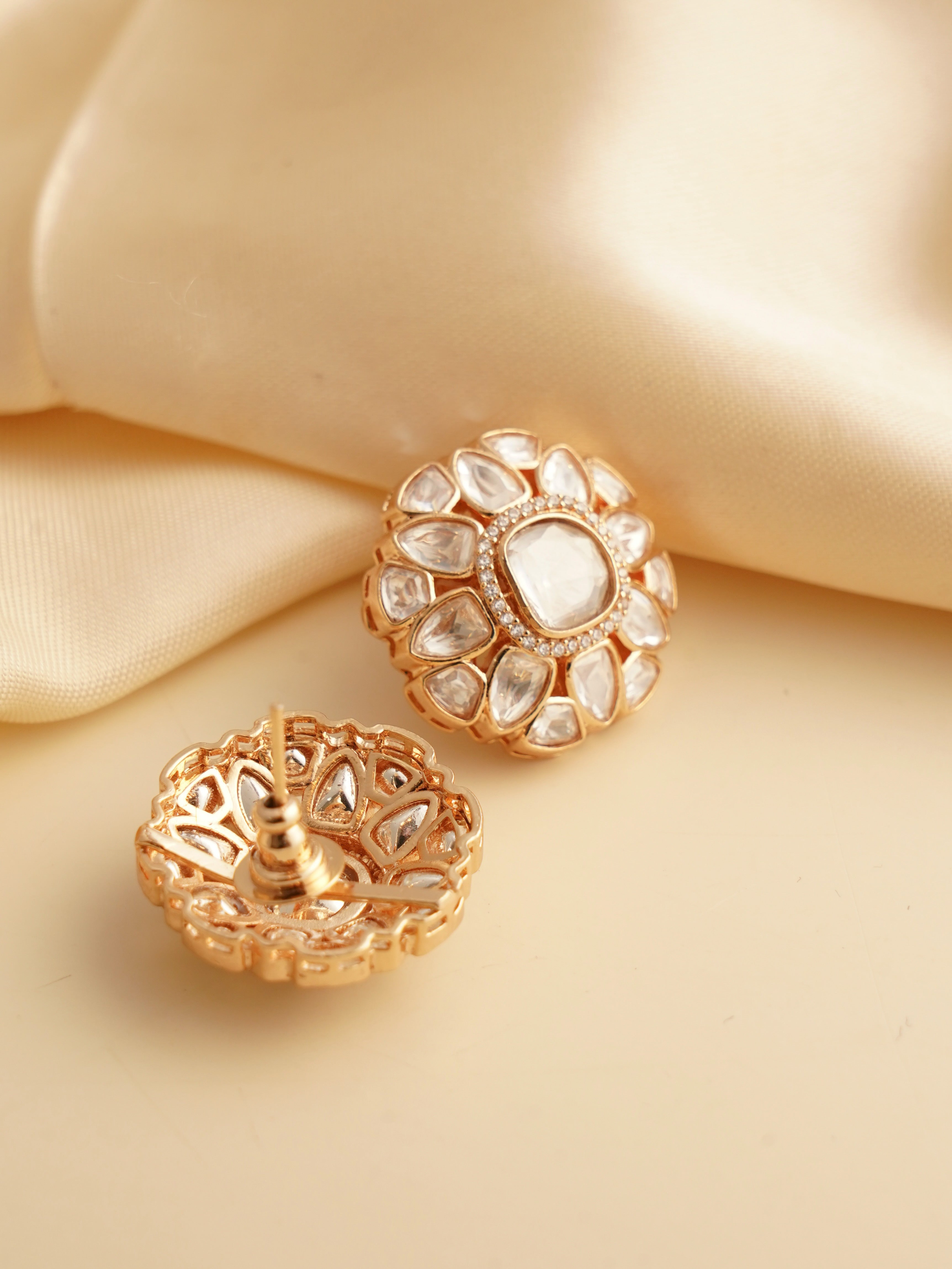 Close-up side view of kundan earrings showing layered petal structure and luminous detail