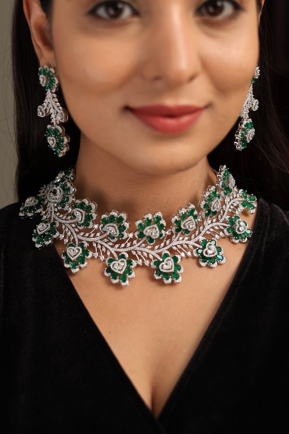 Diamond choker necklace set with floral motifs and emerald-toned accents
