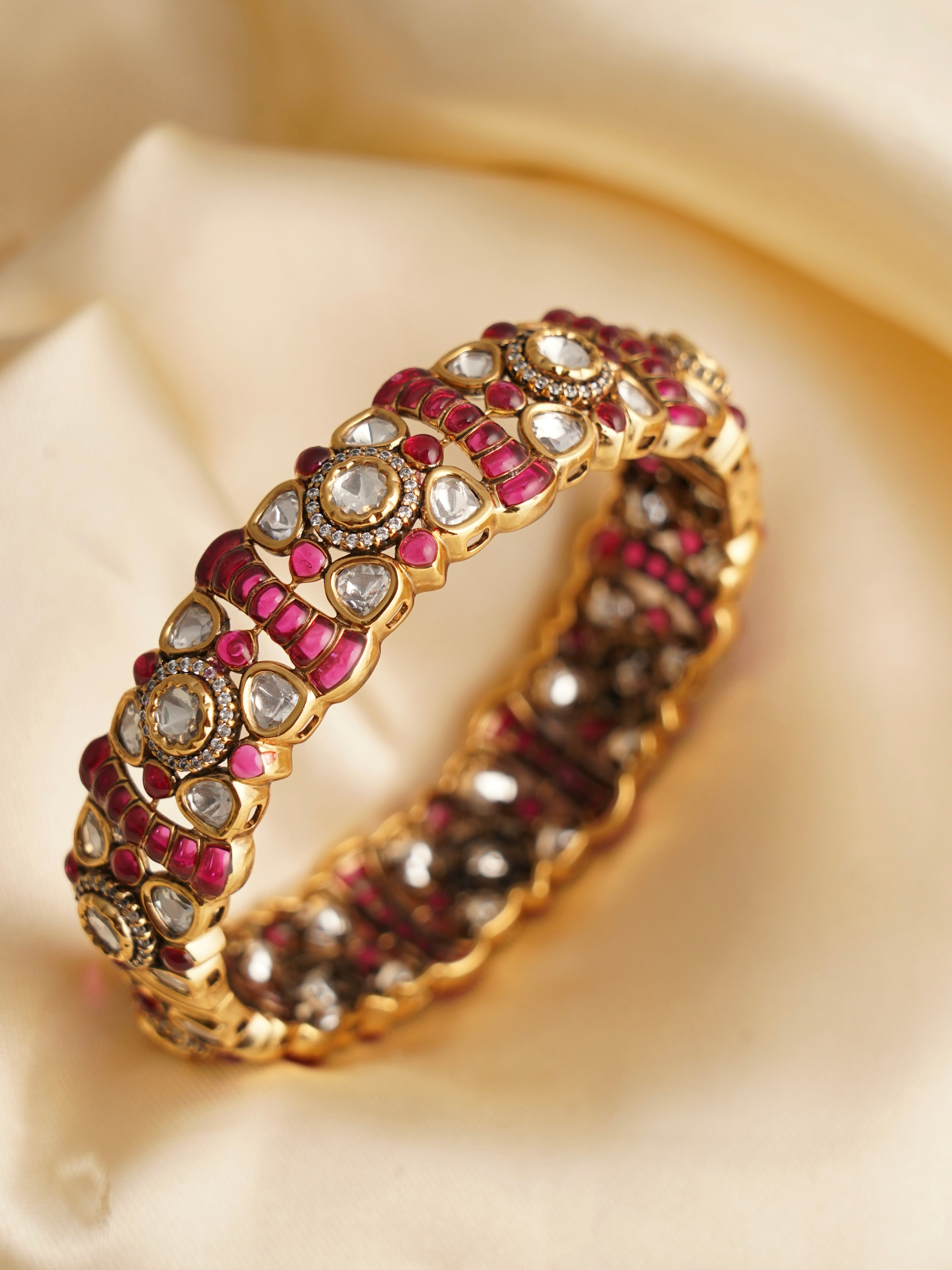 Front view of openable kundan polki kada with textured gold polish