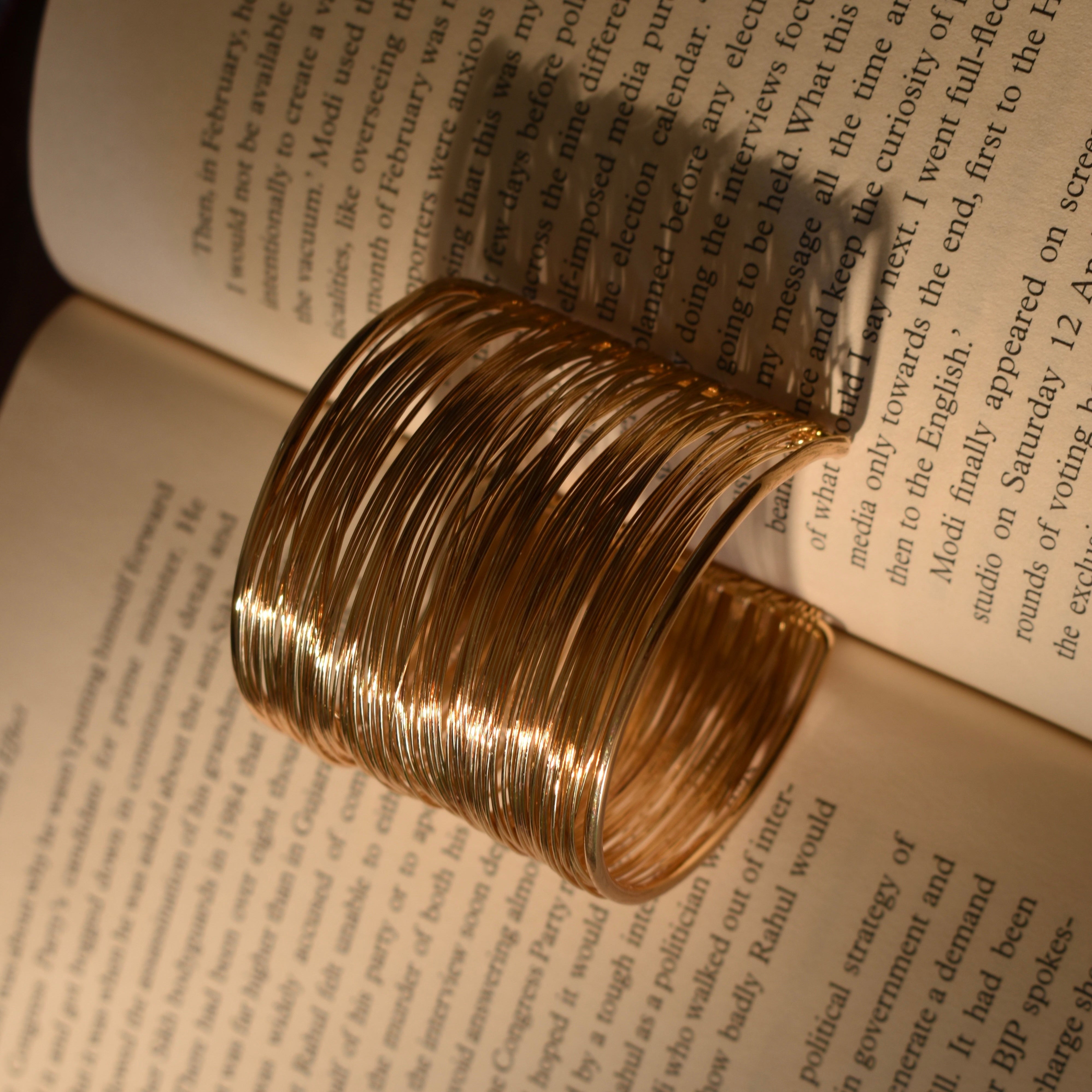 Side view of adjustable bracelet showing pull-string style and copper finish