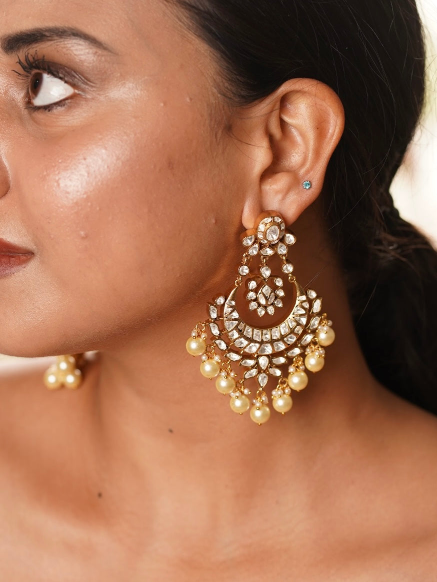 Close-up of chaandbali earrings showcasing moissanite sparkle and delicate curved silhouette