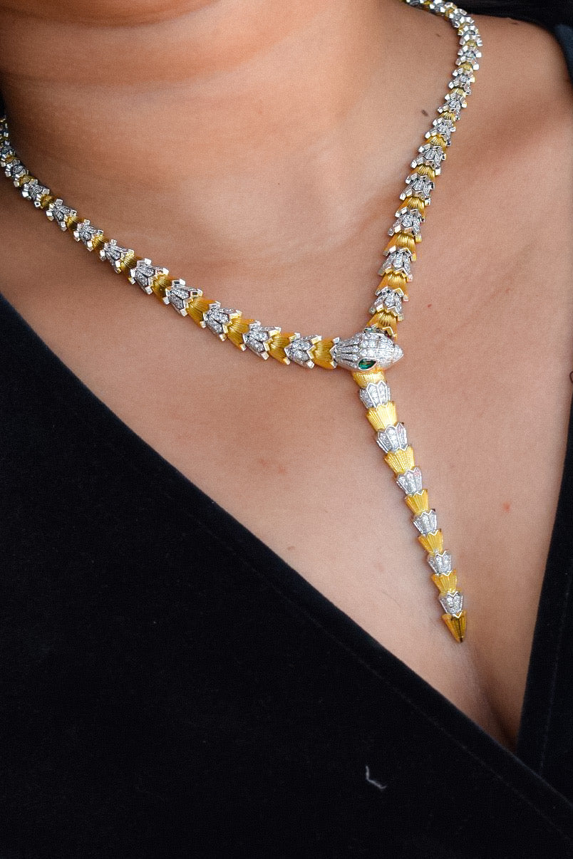 Angled shot of designer silver-toned necklace with matching earring pair