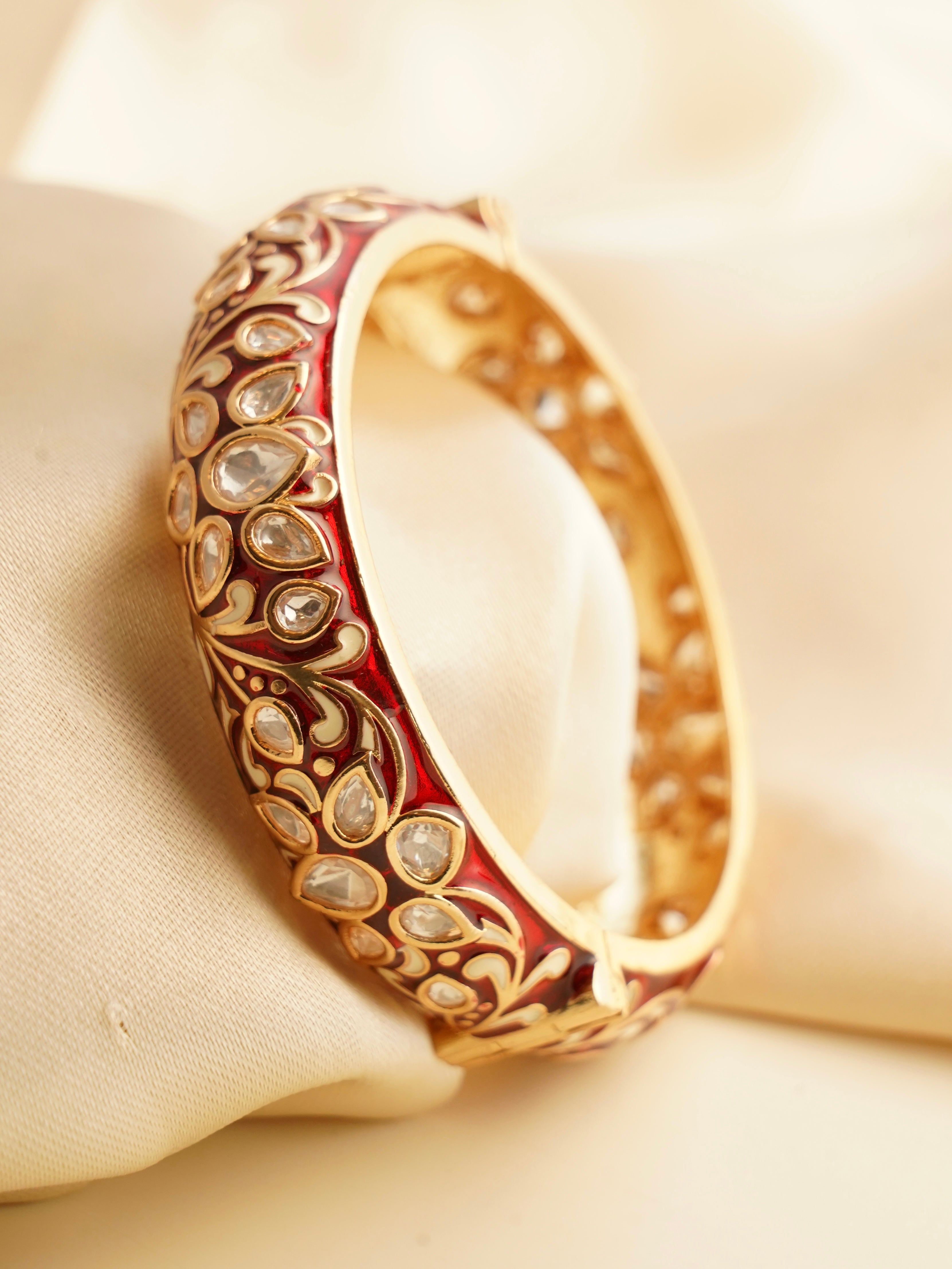 Meenakari kada with vibrant enamel and polki stones in front display