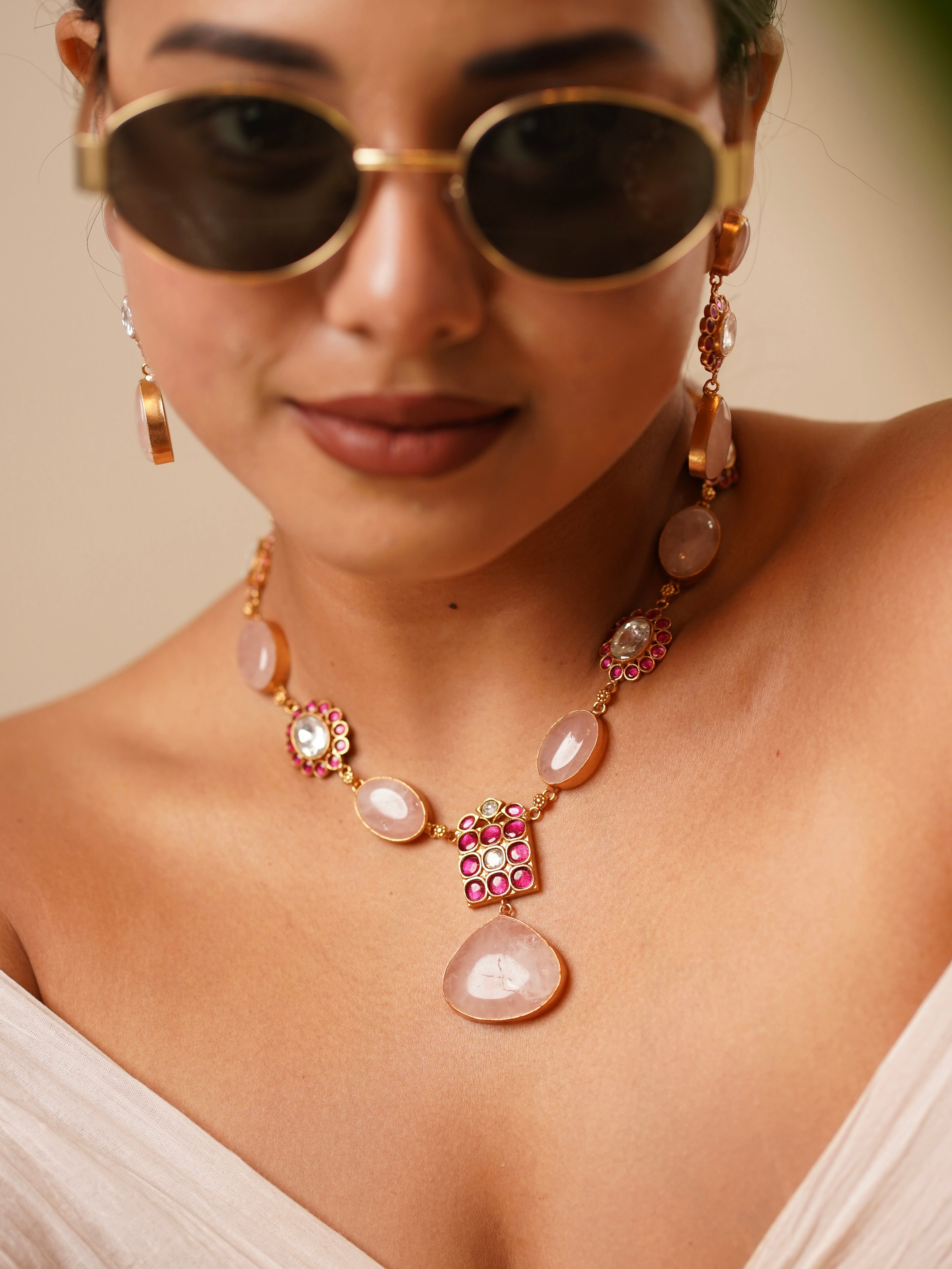 front view of kabachino stone necklace with bold green gemstones and ruby clusters