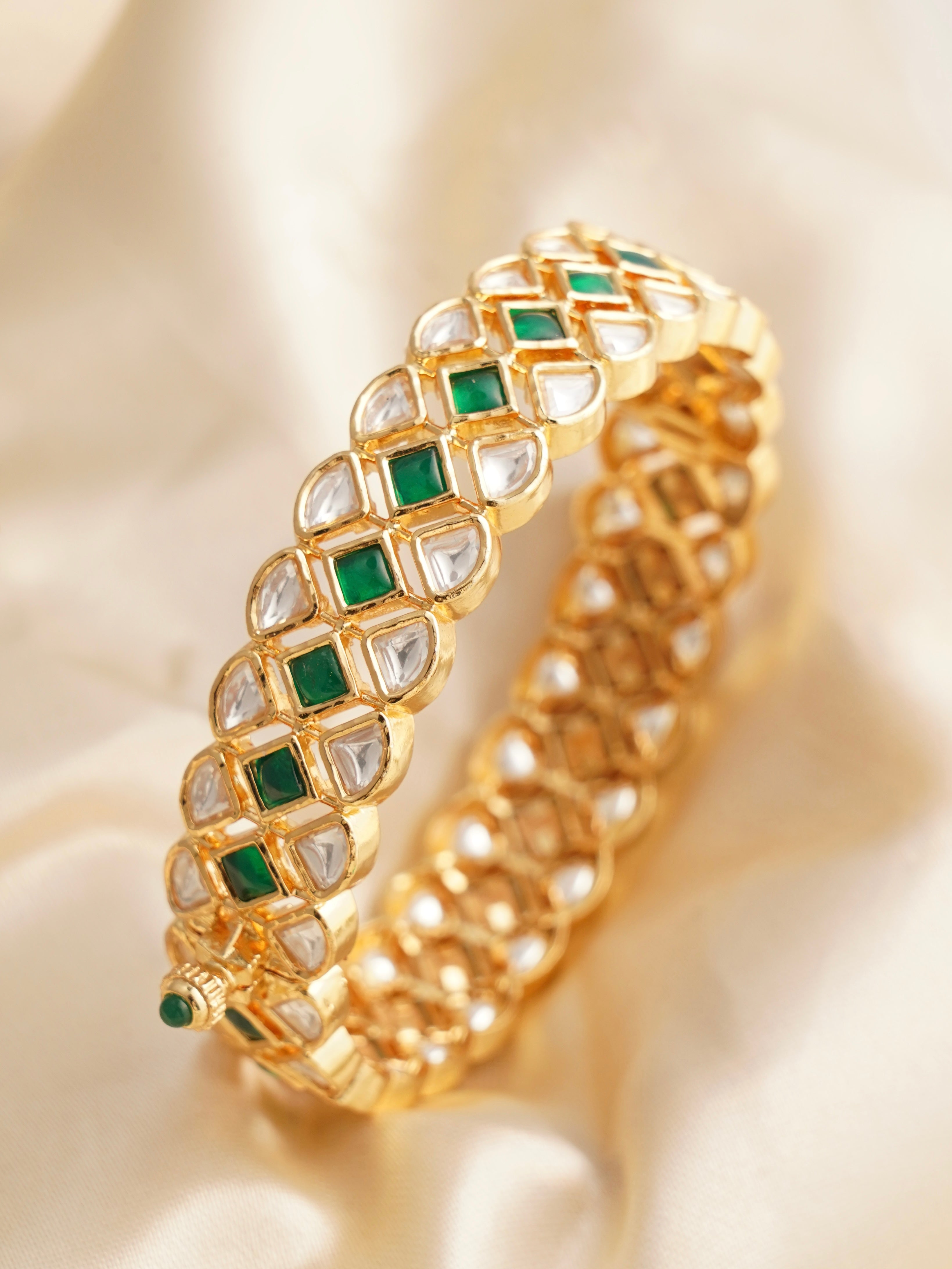 Close-up of openable kundan kada bangle with copper base